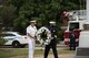 U.S. Navy Vice Admiral Dee L. Mewbourne, U.S. Transportation Command deputy commander, left, and Belland Eric Belland, 375th Civil Engineer Squadron fire chief, right, carry a wreath