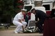 Service members lay wreath on ground