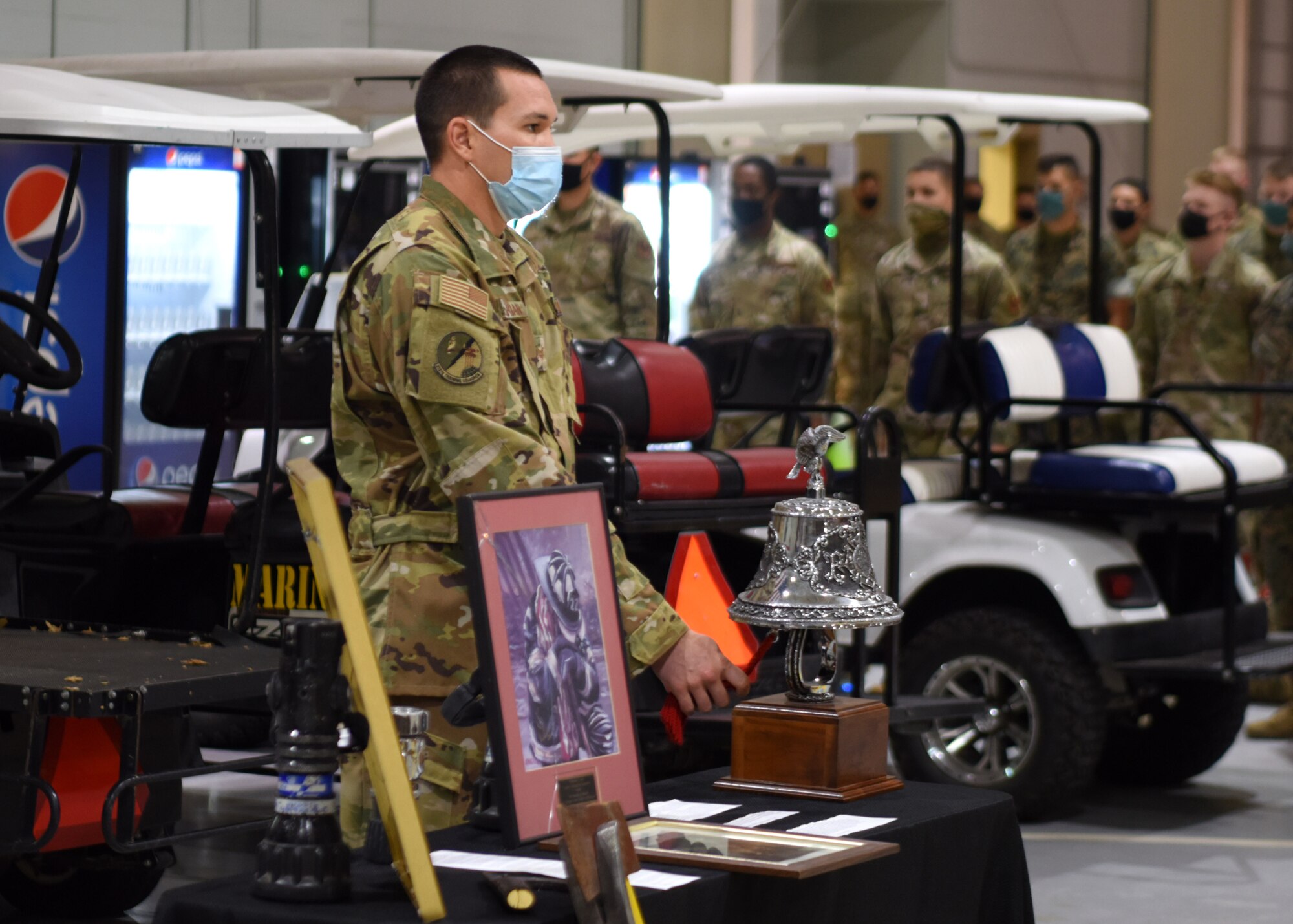 A 312th Training Squadron instructor rings the bell five times during the 9/11 ceremony at the Louis F. Garland Department of Defense Fire Academy on Goodfellow Air Force Base, Texas, September 11, 2020. Each tone was dedicated to those who died during the attacks on 9/11. (U.S. Air Force photo by Airman 1st Class Ethan Sherwood)