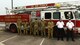 photo of Davis-Monthan Air Force Base fire department members standing in front of a fire engine watching a  9/11 remembrance ceremony at Davis-Monthan Air Force Base, Arizona