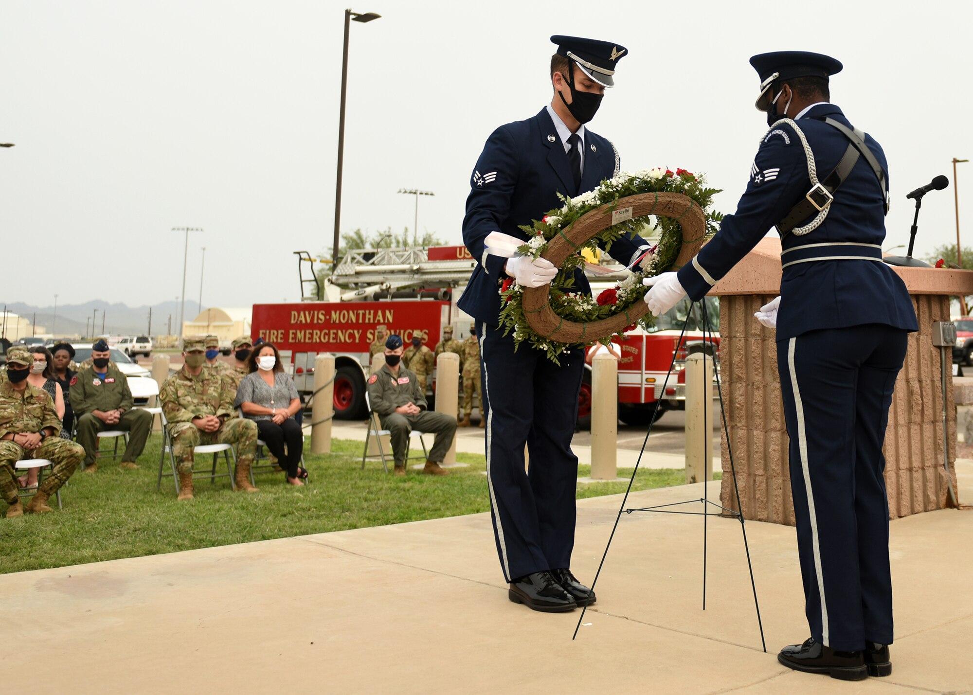 photo of two Air Force Honor Guard members placing a wreath for display during a 9/11 remembrance ceremony at Davis-Monthan Air Force Base, Arizona