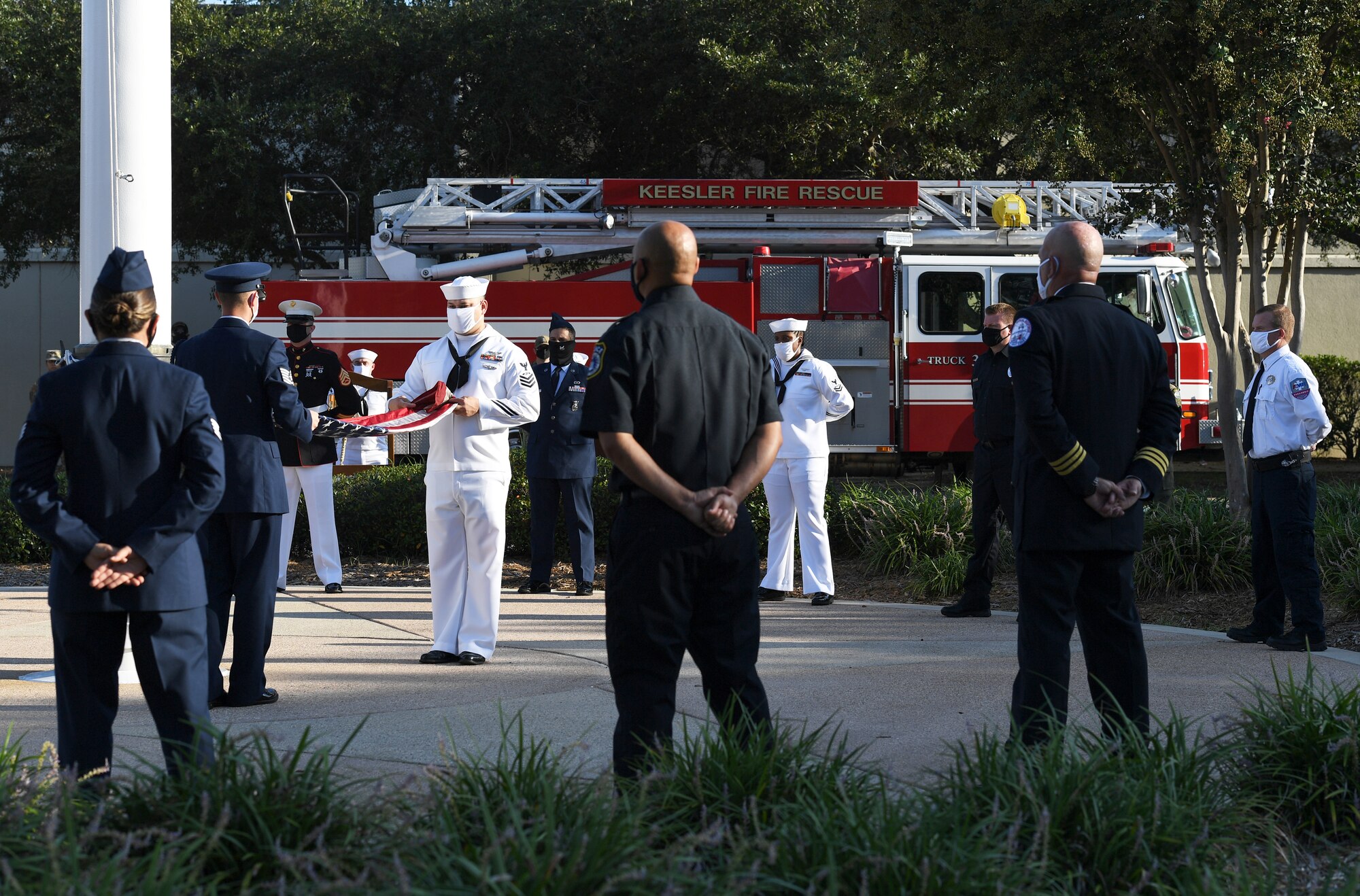 Keesler Airmen, Sailors and Marines participate in a 9/11 memorial ceremony hosted by the Center for Naval Aviation Technical Training Unit Keesler in front of the 81st Training Wing headquarters building at Keesler Air Force Base, Mississippi, Sept. 11, 2020. The event honored those who lost their lives during the 9/11 attacks. (U.S. Air Force photo by Kemberly Groue)