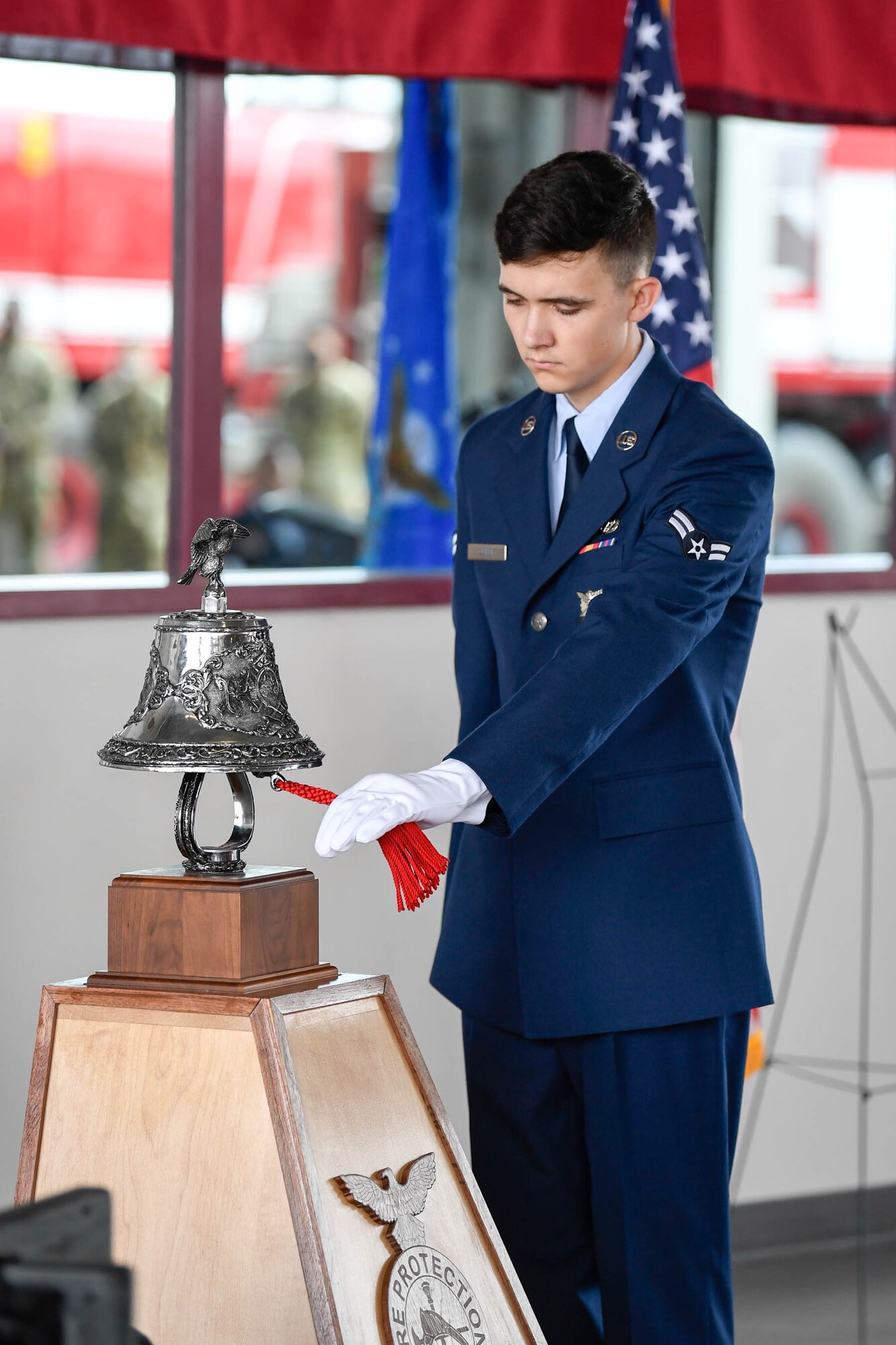 Airman 1st Class Devin Oliver, 436th Civil Engineer Squadron fire protection apprentice, performs the ringing of the bell ceremony during the 19th Anniversary 9/11 memorial event Sept. 11, 2020, at Dover Air Force Base, Delaware. The ringing of the “four fives” is a firefighter tradition that signals and honors when a firefighter has perished in the line of duty. (U.S. Air Force photo by Mauricio Campino)