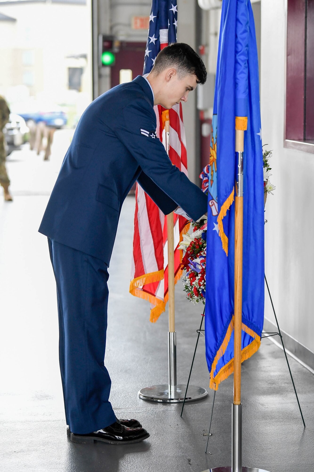 Airman 1st Class Devin Oliver, 436th Civil Engineer Squadron fire protection apprentice, lays a wreath during the 19th Anniversary 9/11 nemorial event Sept. 11, 2020, at Dover Air Force Base, Delaware. A 9/11 memorial sculpture at the Air Mobility Command Museum adjacent to the base includes two pieces of steel from the World Trade Center, a rock from the United Airlines Flight 93 crash site and a block from the damaged portion of the Pentagon. (U.S. Air Force photo by Mauricio Campino)