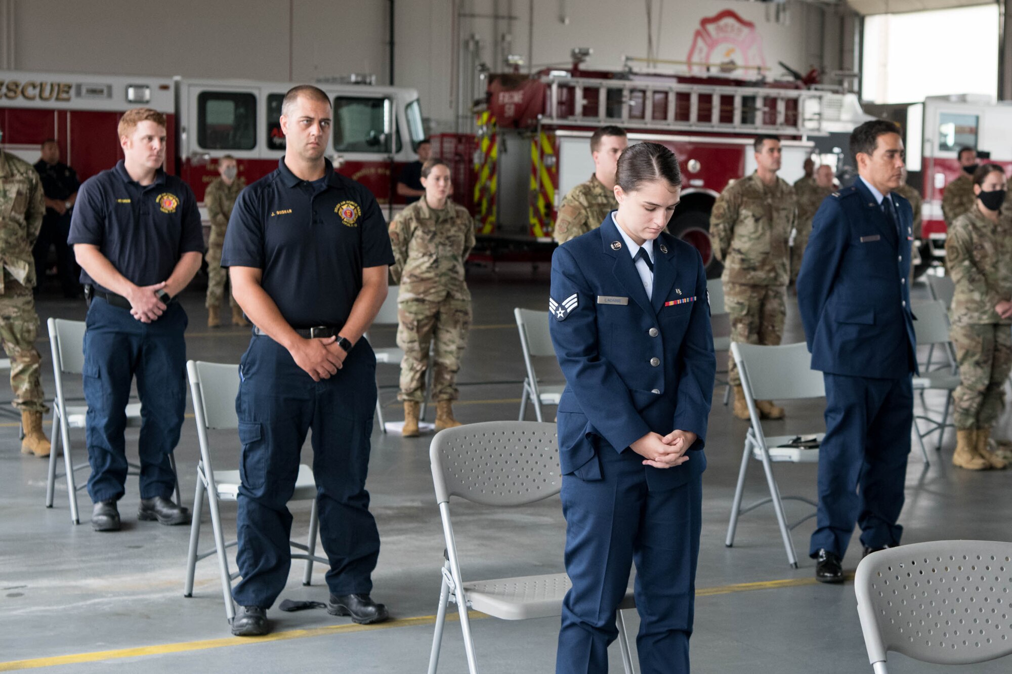 Attendees bow their heads during a prayer at the 19th Anniversary 9/11 memorialservice Sept. 11, 2020, at Dover Air Force Base, Delaware. The memorial event, typically attended by dozens of firefighters, police officers and first responders from the surrounding area, had limited attendance this year due to COVID-19 restrictions. (U.S. Air Force photo by Mauricio Campino)