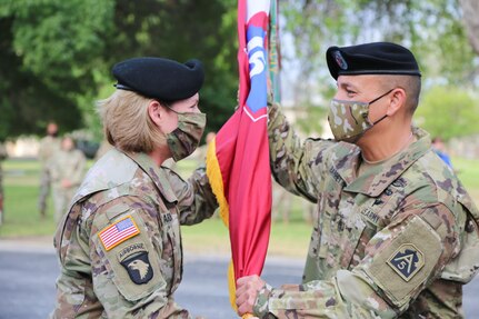 Army commanding general passing flag to command sergeant major.