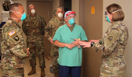 People speaking in the hall of a medical center.