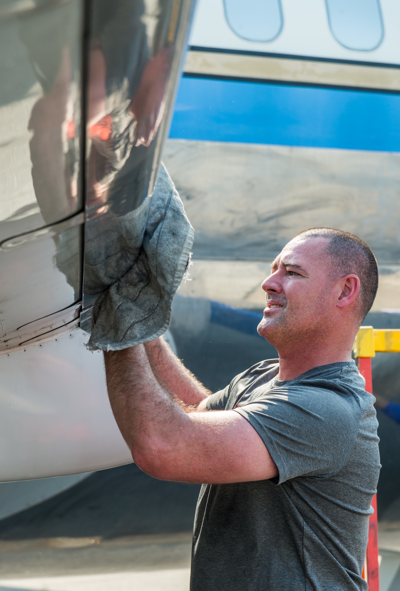 Staff Sgt. Bret Gratien, 436th Maintenance Squadron aircraft hydraulic section noncommissioned officer in charge, removes cleaning compound from the leading edge of the right wing on a McDonnell Douglas VC-9C Aug. 25, 2020, at Air Mobility Command Museum on Dover Air Force Base, Delaware. Gratien, along with other members of the hydraulic section, volunteered to strip, clean and polish the shiny aluminum skin of the aircraft formerly designated as Air Force Two. (U.S. Air Force photo by Roland Balik)