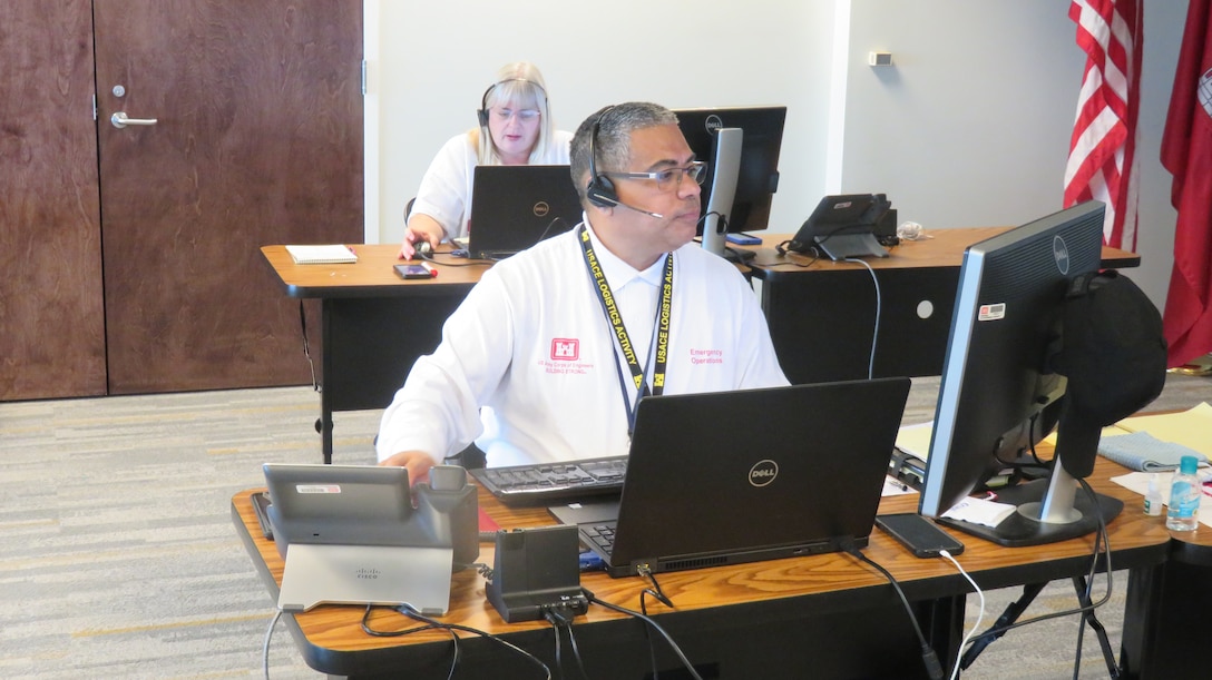 Jose Diaz, a logistics management specialist for the U.S. Army Corps of Engineers (USACE) from Millington, Tennessee, talks to a Hurricane Laura disaster survivor seeking information on the temporary roofing program at a call center in Jacksonville Florida.  Operation Blue Roof is a program managed by USACE on behalf of FEMA that installs fiber-reinforced sheeting to cover damaged roofs until arrangements can be made for permanent repairs.