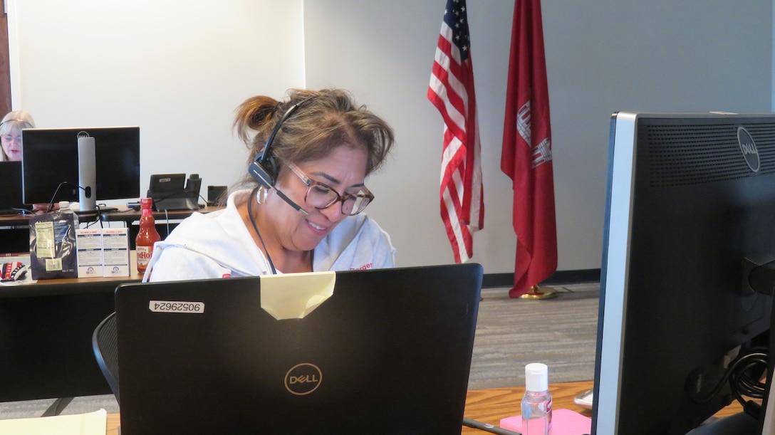 Hilda de la Paz, fleet manager for the U.S. Army Corps of Engineers (USACE) Galvaston District, talks to a Hurricane Laura disaster survivor seeking information on the temporary roofing program at a call center in Jacksonville Florida.  Operation Blue Roof is a program managed by USACE on behalf of FEMA that installs fiber-reinforced sheeting to cover damaged roofs until arrangements can be made for permanent repairs.