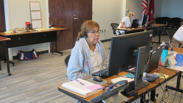 Yolanda Bringhurst, administrative specialist for the U.S. Army Corps of Engineers (USACE) Jacksonville District, talks to a Hurricane Laura disaster survivor seeking information on the temporary roofing program at a call center in Jacksonville Florida.  Operation Blue Roof is a program managed by USACE on behalf of FEMA that installs fiber-reinforced sheeting to cover damaged roofs until arrangements can be made for permanent repairs.