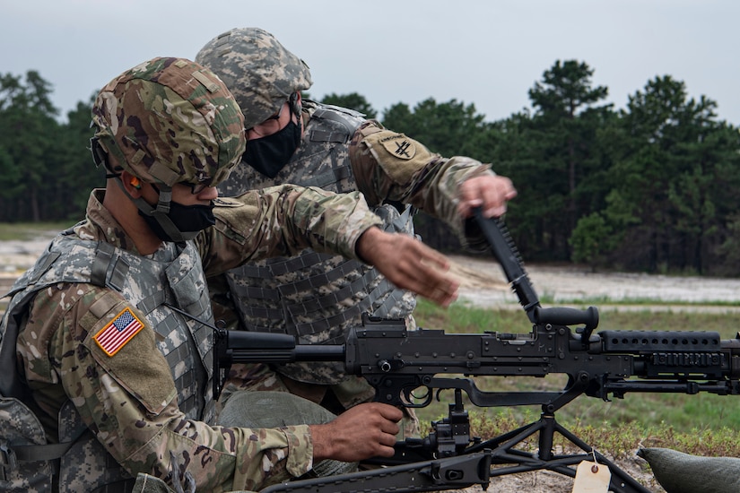 Photo of soldier clearing an M240.