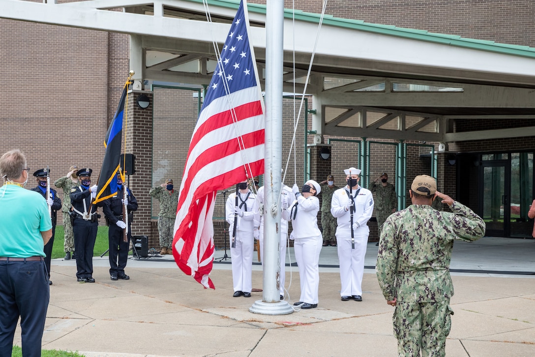 Norfolk Naval Shipyard Sailors hoist the flag for the Patriot Day Remembrance Ceremony in honor of those who have fallen.