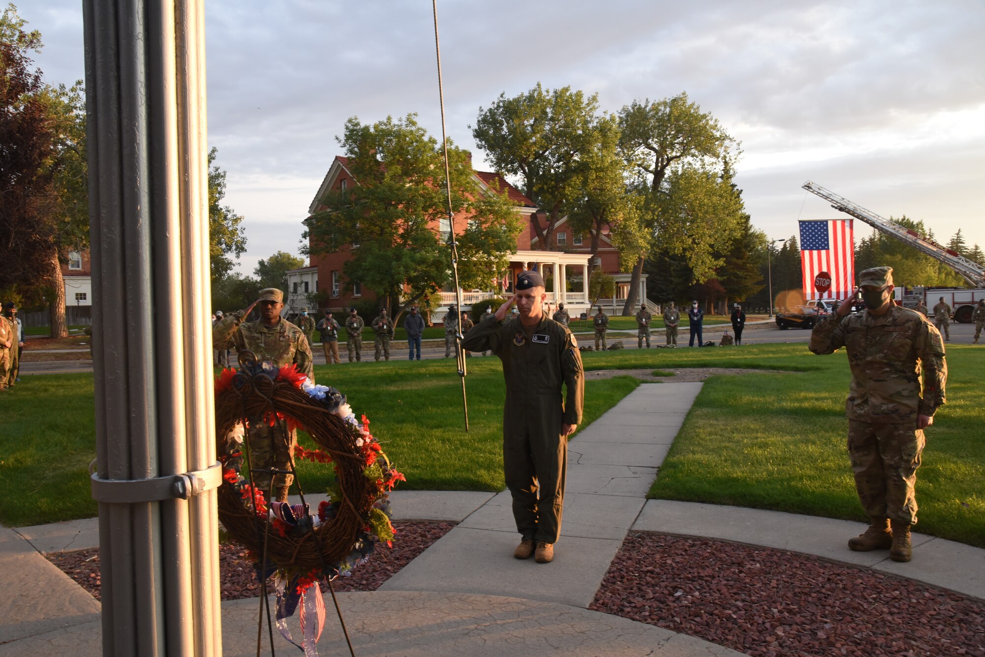troops saluting at wreath