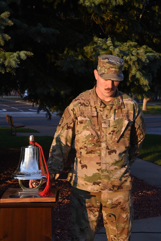 airman ringing a memorial bell