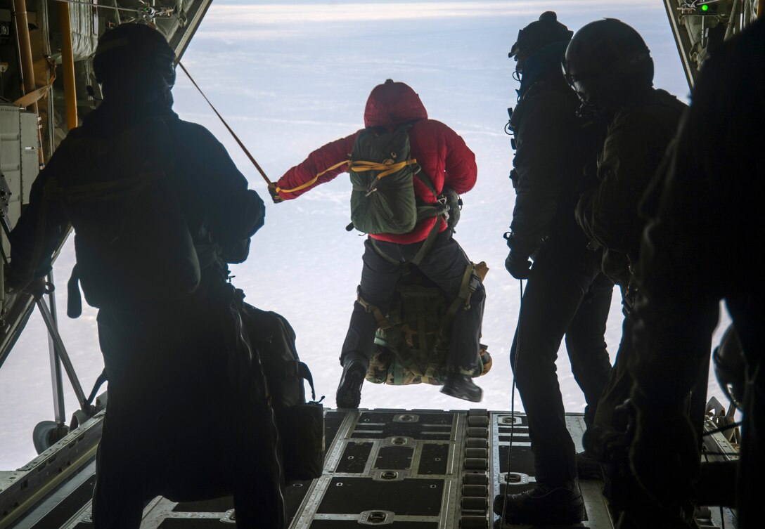 Members of the 212th Rescue Squadron, pararescuemen, combat rescue officers, and Survival, Evasion, Resistance and Escape specialists jump out of a HC-130J Combat King II assigned to the 211th Rescue Squadron in response to a simulated alert rescue call at Deadhorse, Alaska, in support of exercise Arctic Eagle 2020, Feb. 25, 2020. The Alaska National Guard is hosting exercise Arctic Eagle 2020, a joint-training exercise, Feb. 20 to March 6, 2020 throughout Alaska, including Joint Base Elmendorf-Richardson, Eielson Air Force Base, Fort Wainwright, the Yukon-Kuskokwim Delta and as far north as Teshekpuk Lake. As a homeland security and emergency response exercise, Arctic Eagle 20 is designed to increase the National Guard’s ability and effectiveness to operate in the extreme cold-weather conditions found in Arctic environments. (U.S. Air Force photo by Senior Airman Xavier Navarro)
