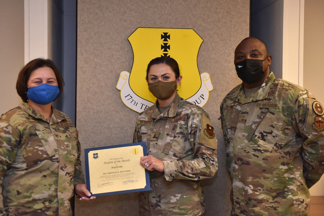 U.S. Air Force Col. Angelina Maguinness, 17th Training Group commander, and Chief Master Sgt. Charmane Tatum, 17th TRG superintendent, present 2nd Lt. Kristen Ketterer, 315th Training Squadron student, with her award. The 315th TRS’ vision is to develop combat-ready intelligence, surveillance and reconnaissance professionals and promote an innovative squadron culture and identity unmatched across the U.S. Air Force. (U.S. Air Force photo by Staff Sgt. Seraiah Wolf)