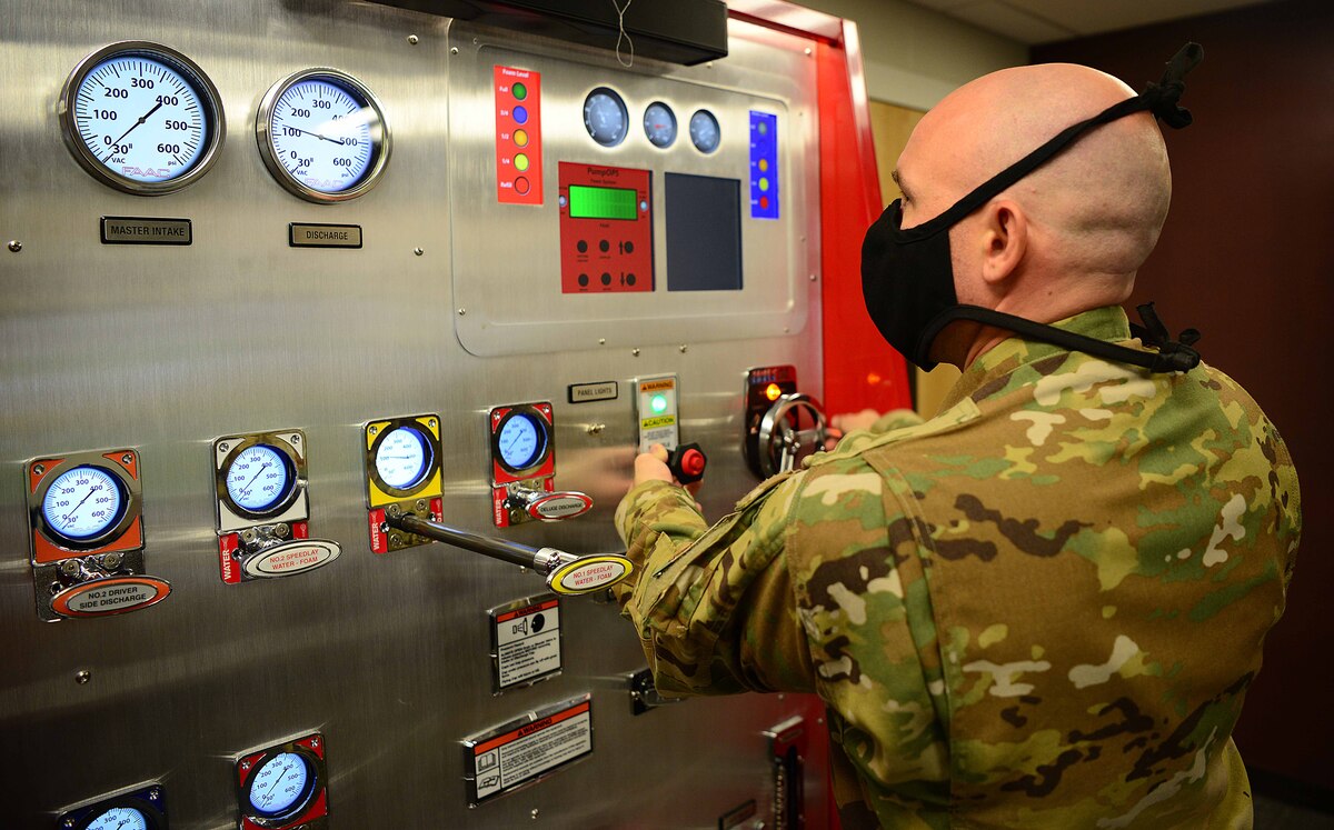 U.S. Air Force Tech. Sgt. Scott Ruester, the 354th Fire Emergency Services assistant chief of operations, demonstrates a fire engine simulator at the main fire station on Eielson Air Force Base, Alaska, Sept. 11, 2020, at the main fire station on Eielson Air Force Base, Alaska, Sept. 11, 2020. Airmen from the Eielson Fire Department are knowledgeable in various skills to include structural response, aircraft rescue and firefighting, hazardous material handling, emergency medical services and technical rescue. (U.S. Air Force photo by Staff Sgt. Sean Martin)