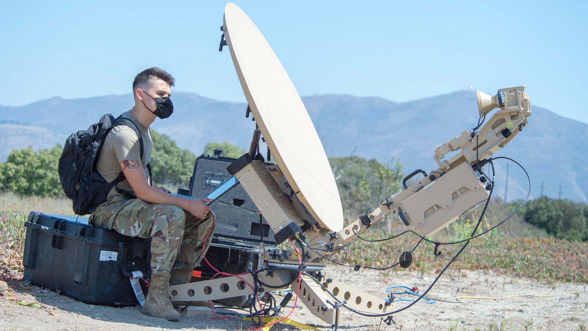 Senior Airman Peyton Van Nest, 51st Combat Communications Special Mission Squadron radio frequency transmission system technician from Robins Air Force Base, Georgia, sets up a satellite communications antenna during Exercise Agile Reaper, Sept. 5, 2020, at Naval Air Station Point Mugu, California. This routine exercise supports Total Force training and education of aircrew and support personnel to strengthen relationships, improve readiness, and boost lethality. (U.S. Air Force photo by Senior Airman Collette Brooks)