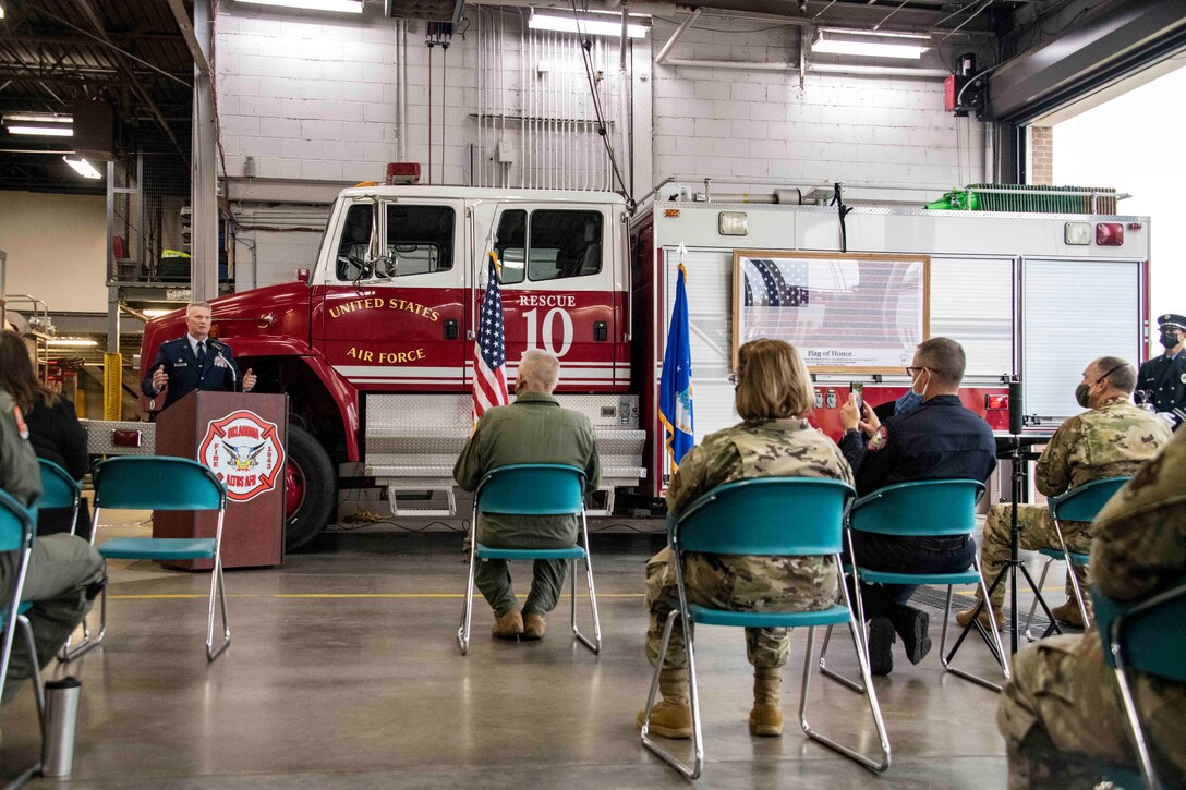 man stands in front of a backdrop