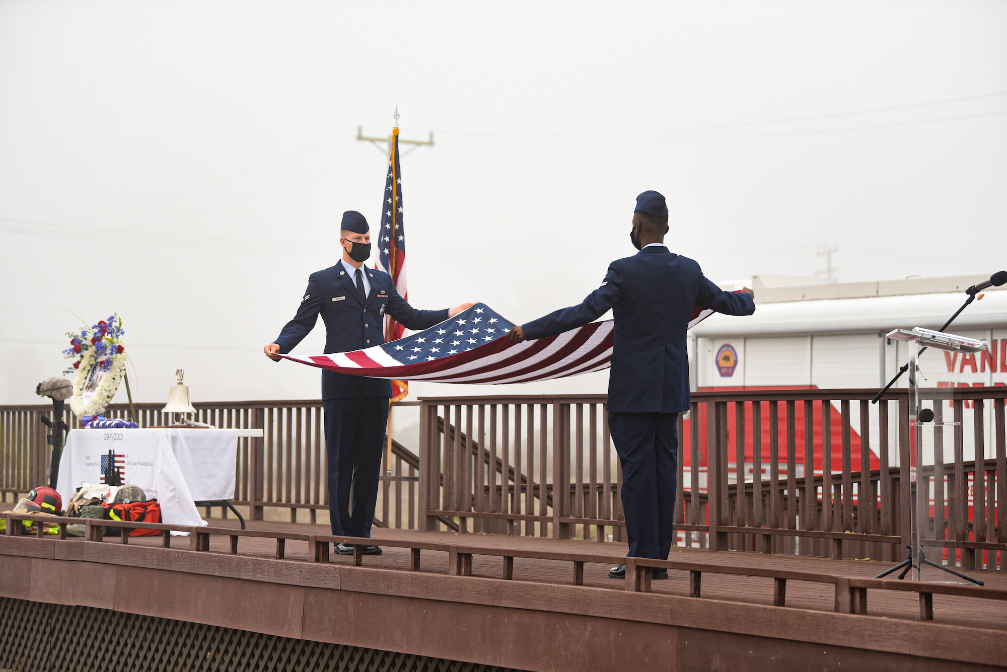 Honor guard members fold a flag at the annual 9/11 Remembrance Ceremony Sept. 11, 2020, at Vandenberg Air Force Base, Calif. During the terrorist attacks that took place at the World Trade Center in New York City, N.Y., on Sept. 11, 2001, 343 firefighters, 23 New York Police Department officers, and 37 Port Authority officers were killed in the line of duty, while responding. During the 9/11 Remembrance Ceremony, speeches were given to honor those who gave the ultimate sacrifice to save others. (U.S. Air Force photo by Senior Airman Hanah Abercrombie)