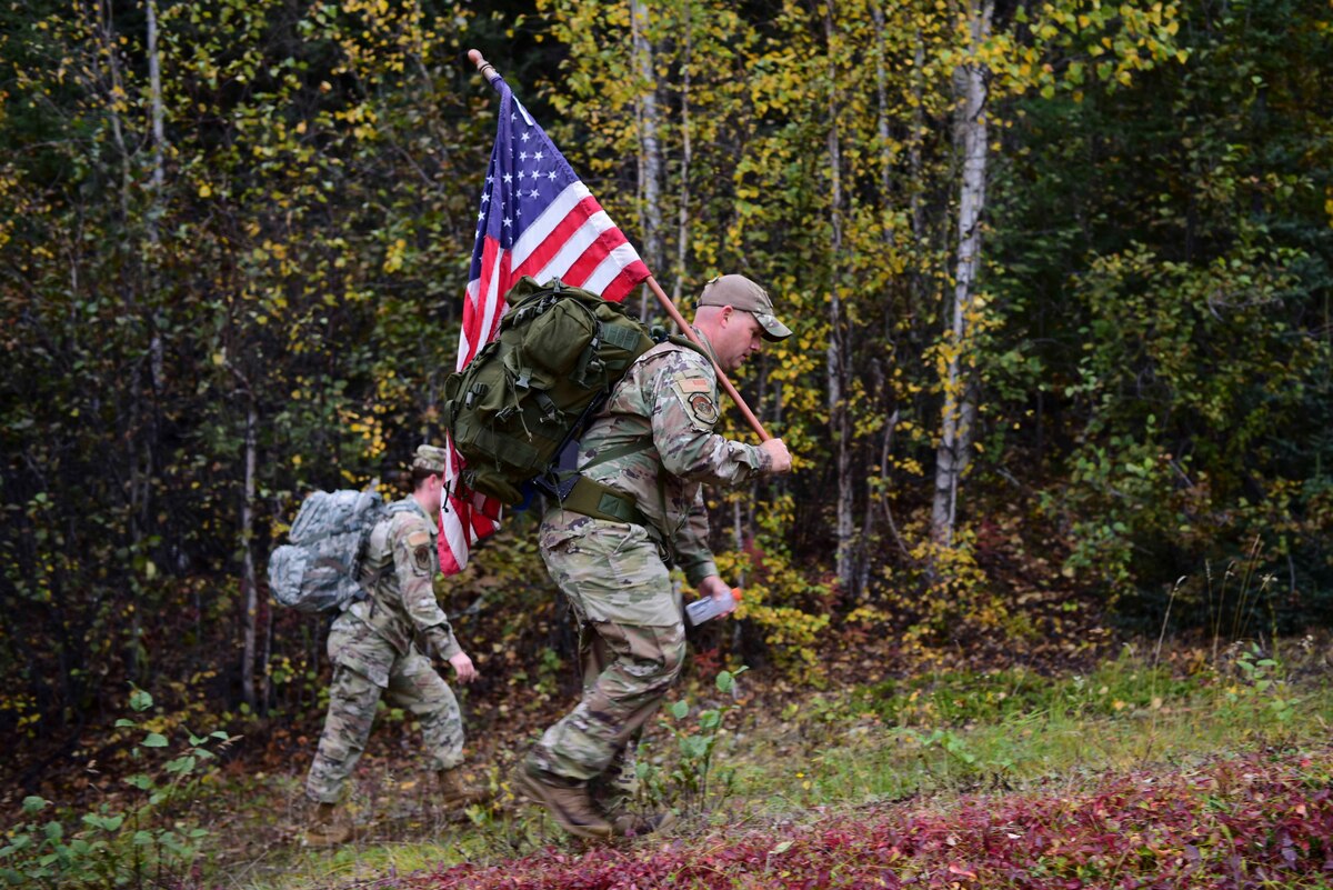 U.S. Air Force Tech. Sgt. Brandon Brown, the 354th Security Forces Squadron noncommissioned officer head of operations, carries an American flag during a 9/11 Remembrance Ruck on Eielson Air Force Base, Alaska, Sept. 11, 2020.