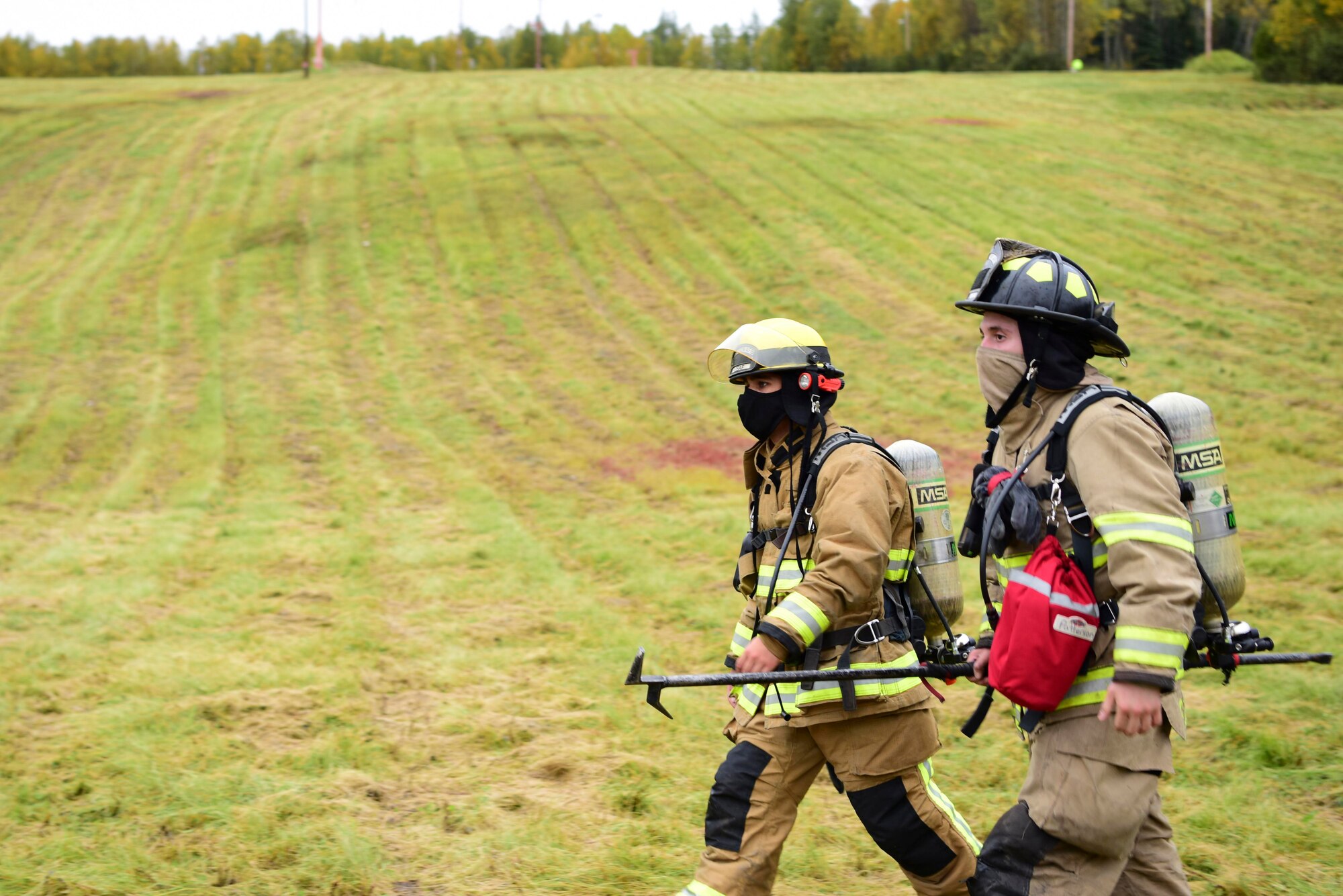 U.S. Air Force Airman 1st Class Logan Schaufelberger (left), a 354th Civil Engineering Squadron (CES) firefighter, and Senior Airman Alexander Kenneth Stewart, a 354th CES fire department vehicle operator, participate in a 9/11 Remembrance Ruck on Eielson Air Force Base, Alaska, Sept. 11, 2020.