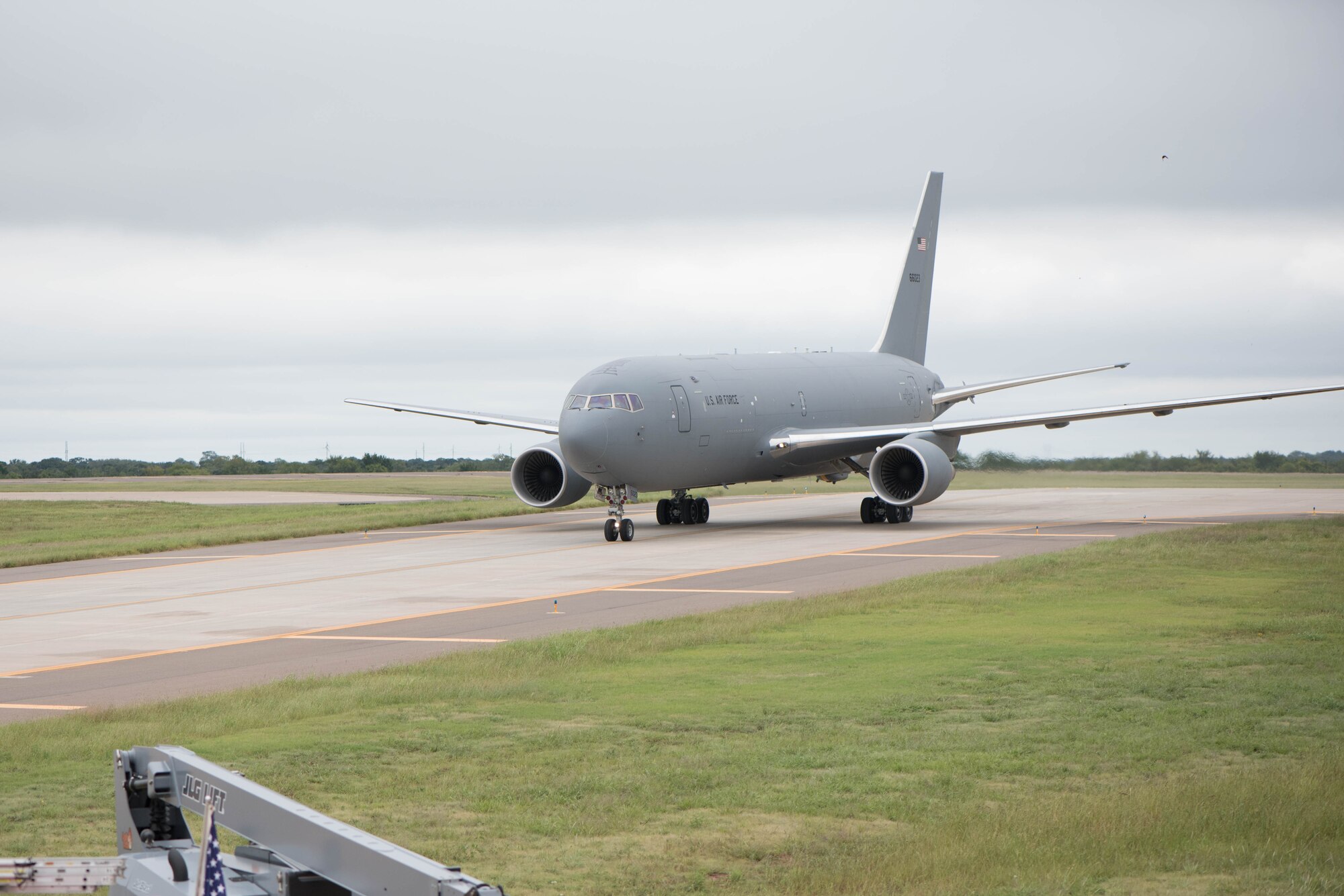 Gray airplane taxis on runway