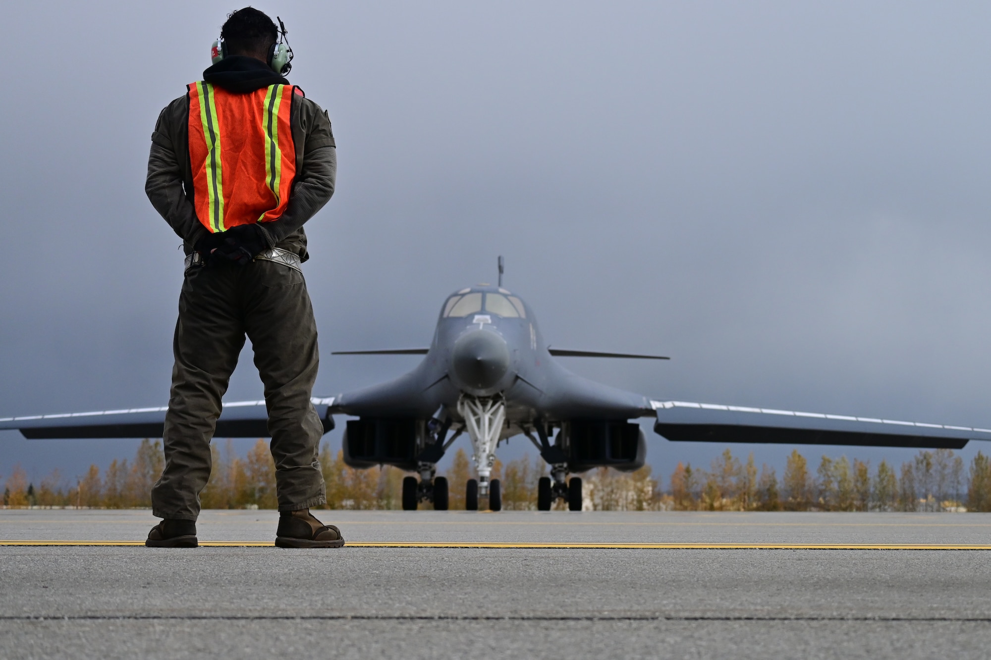 Photo of Airman marshaling a B-1