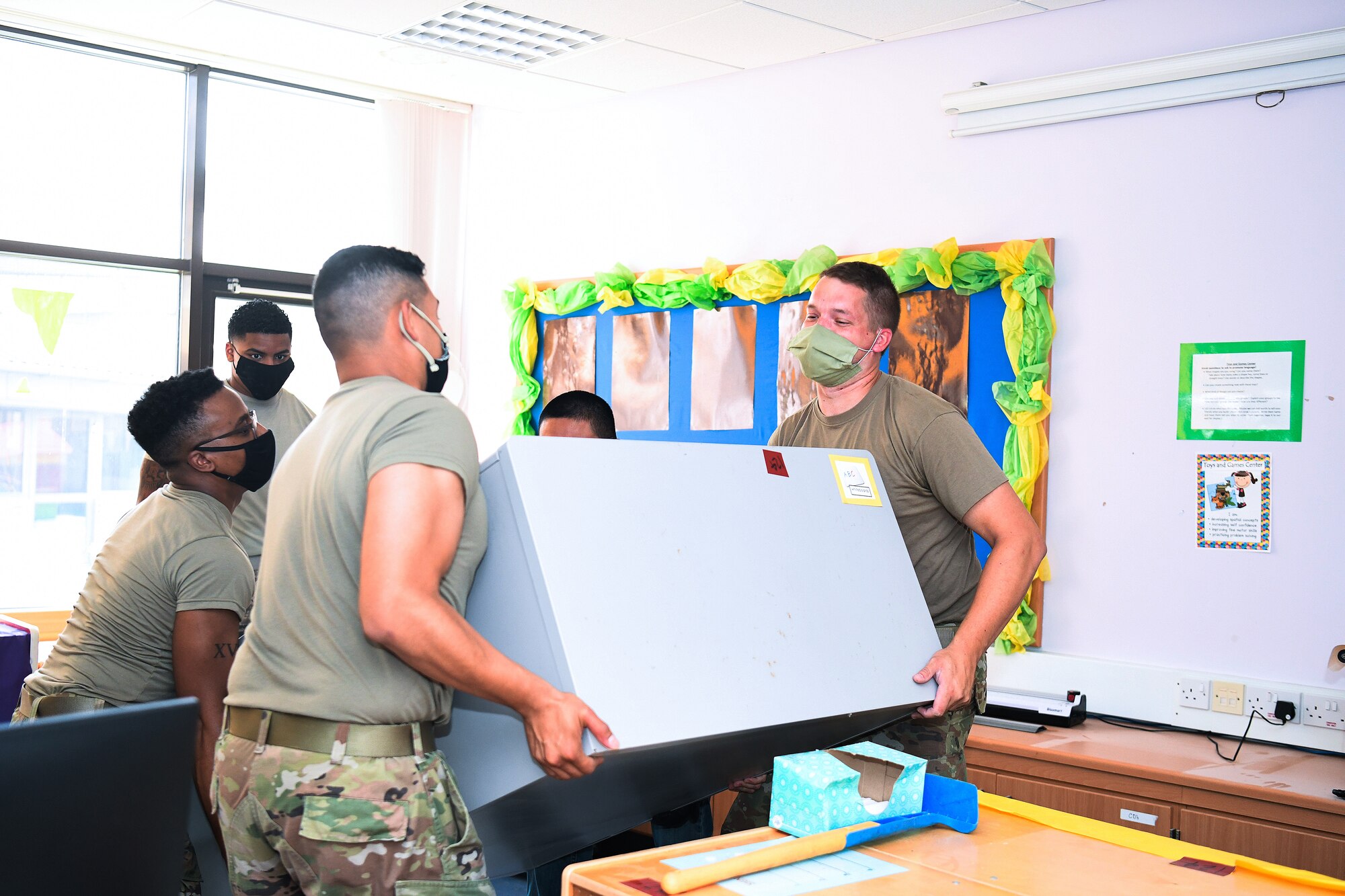 48th Fighter Wing Airmen organize a Lakenheath Elementary School classroom at Royal Air Force Lakenheath, England, Aug. 18, 2020.  More than 300 personnel from squadrons across the installation volunteered to prepare the classrooms for the students’ arrival. (U. S. Air Force photo by Senior Airman Shanice Williams-Jones)