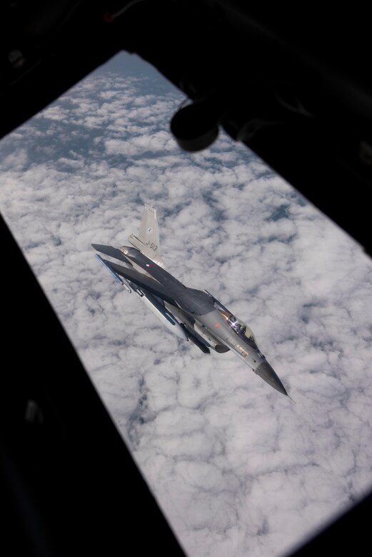 A Royal Netherlands Air Force F-16 Fighting Falcon aircraft peels away from a U.S. Air Force KC-135 Stratotanker aircraft assigned to the 100th Air Refueling Wing, Royal Air Force Mildenhall, England, during exercise Point Blank over the North Sea, Sept. 10, 2020. The KC-135 Stratotanker supports the sharpening of combat readiness and tactical proficiency in allies and partners necessary for maintaining ready forces capable of deterring adversaries and ensuring the collective defense of the NATO alliance. (U.S. Air Force photo by Airman 1st Class Joseph Barron)