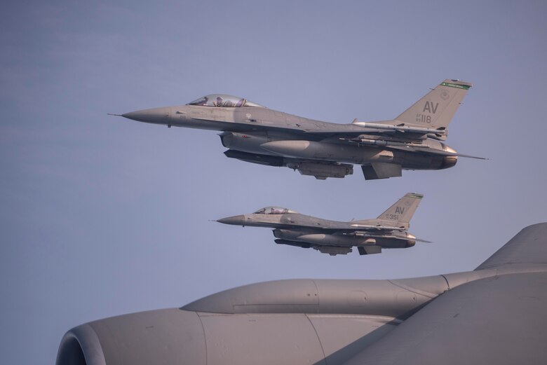 Two F-16 Fighting Falcon aircraft assigned to the 31st Fighter Wing, Aviano Air Base, Italy, fly off the wing of a KC-135 Stratotanker aircraft assigned to the 100th Air Refueling Wing, Royal Air Force Mildenhall, England, during exercise Point Blank over the North Sea, Sept. 10, 2020. The KC-135 Stratotankers provide aerial refueling capability that expand the lethality of Air Force, allied and partner-nation aircraft. (U.S. Air Force photo by Airman 1st Class Joseph Barron)