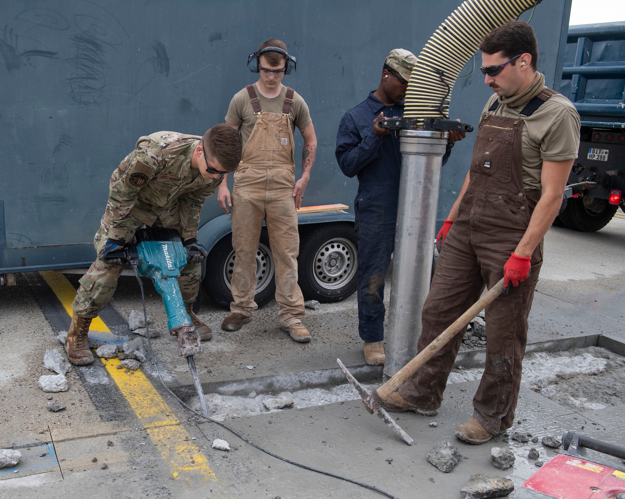 U.S. Air Force Airmen from the 52nd Civil Engineer Squadron pavements and construction equipment shop use a jackhammer on concrete at Spangdahlem Air Base, Germany, Sept. 10, 2020. The Airmen, known as the Dirt Boyz, consistently perform repairs to the flightline to ensure the 52 FW mission can be accomplished. (U.S. Air Force photo by Airman 1st Class Alison Stewart)