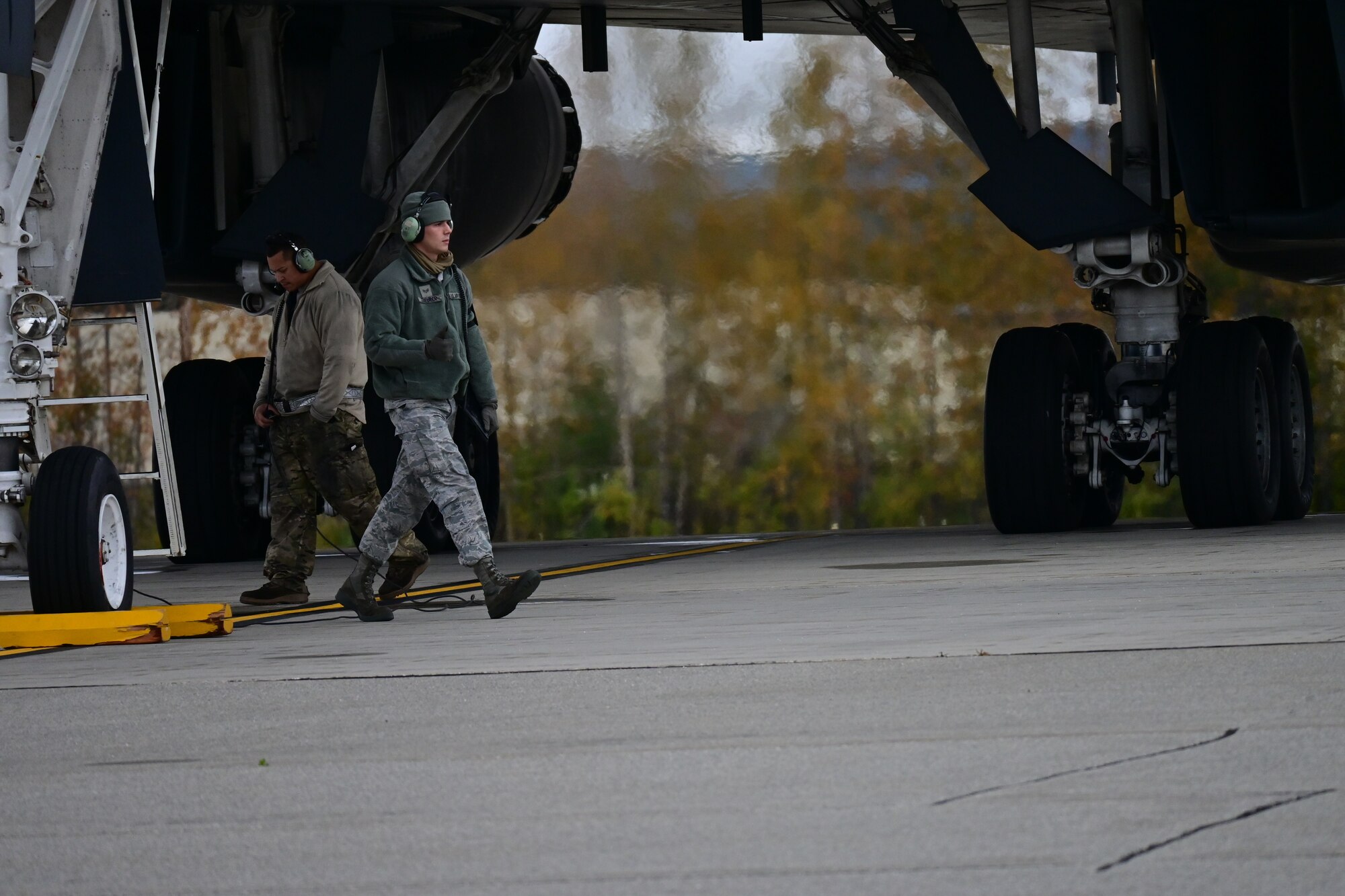 Photo of Airman talking on flight line at night.