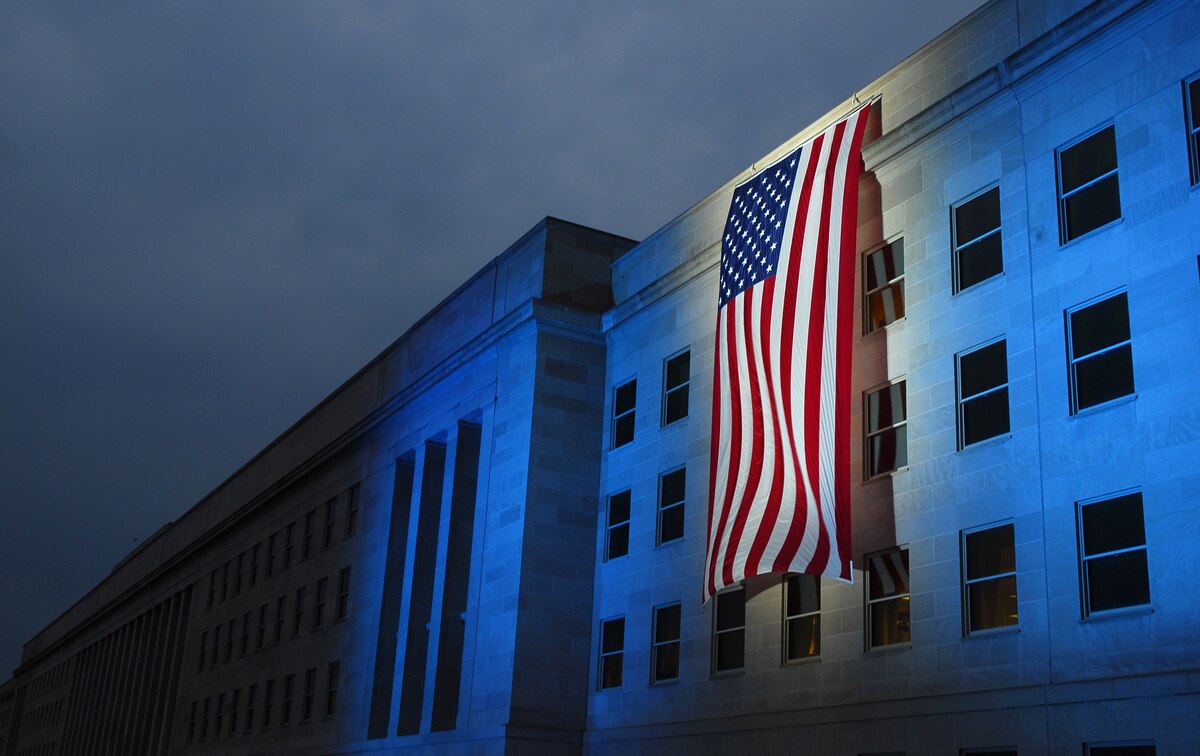 A memorial flag is illuminated near the spot where American Airlines Flight 77 crashed into the Pentagon on Sept. 11, 2001.