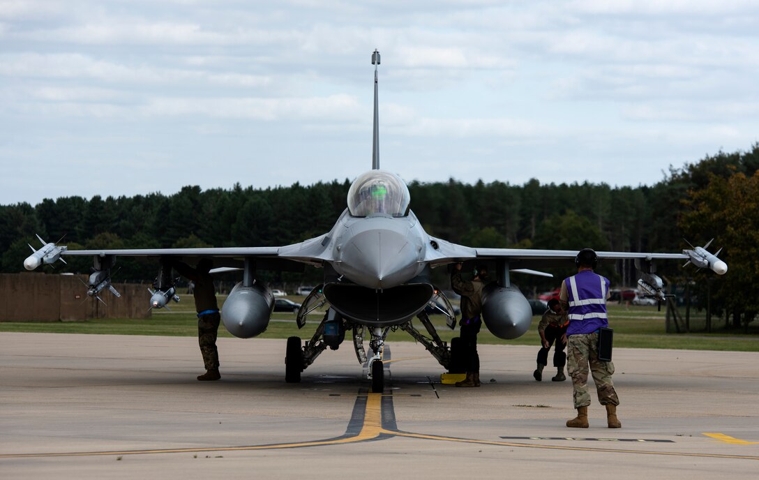 Maintenance crew, assigned to the 31st Fighter Wing, Aviano Air Base, Italy, perform pre-flight checks on an F-16 Fighting Falcon at Royal Air Force Lakenheath, England, Sept. 10, 2020. The 510th FS is conducting close air support training with the 321st Special Tactics Squadron, the 19th Regiment Royal Artillery and the 2nd Air Support Operations Squadron to improve combat capabilities and interoperability between allied nations. (U.S. Air Force photo by Airman 1st Class Jessi Monte)
