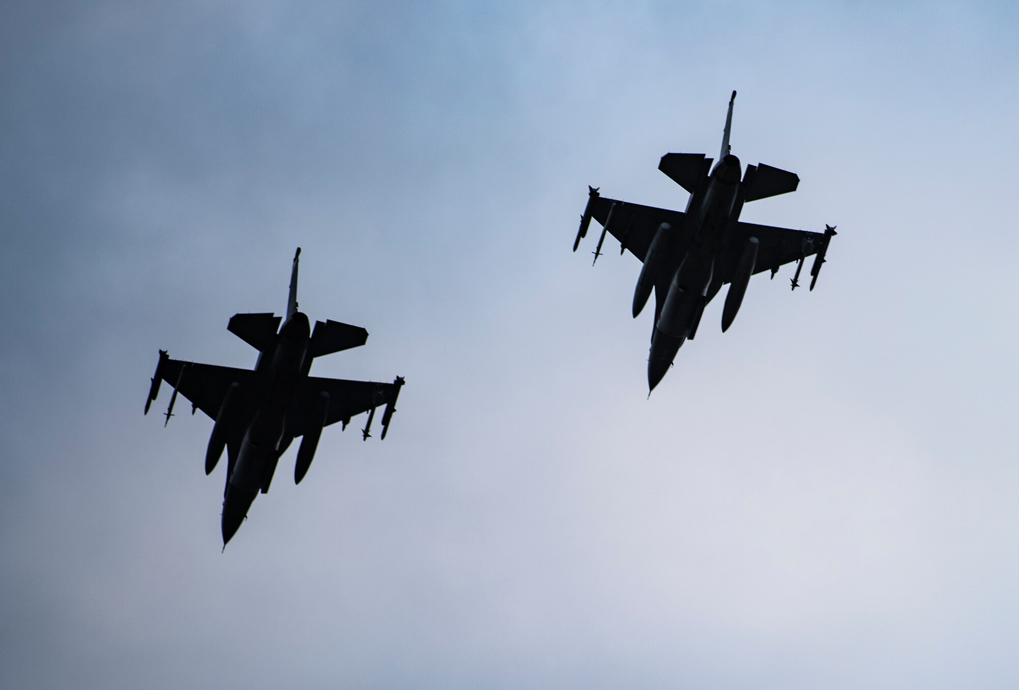 Two F-16 Fighting Falcons, assigned to the 510th Fighter Squadron, Aviano Air Base, Italy, fly over Royal Air Force Lakenheath, England, Sept. 10, 2020. The 510th FS is conducting close air support training with the 321st Special Tactics Squadron, the 19th Regiment Royal Artillery and the 2nd Air Support Operations Squadron to improve combat capabilities and interoperability between allied nations. (U.S. Air Force photo by Airman 1st Class Jessi Monte)