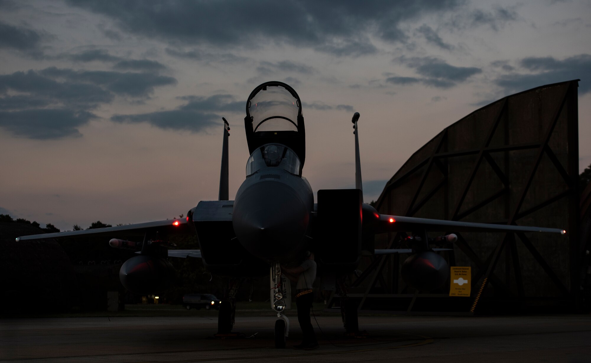 A U.S. Air Force F-15C Eagle assigned to the 493rd Fighter Squadron awaits completion of pre-flight checks at Royal Air Force Lakenheath, England, Sept. 8, 2020. Night Flying Exercises provide 48th Fighter Wing aircrew and support personnel the experience needed to maintain a ready force capable of ensuring the collective defence of the NATO alliance. (U.S. Air Force photo by Airman 1st Class Jessi Monte)