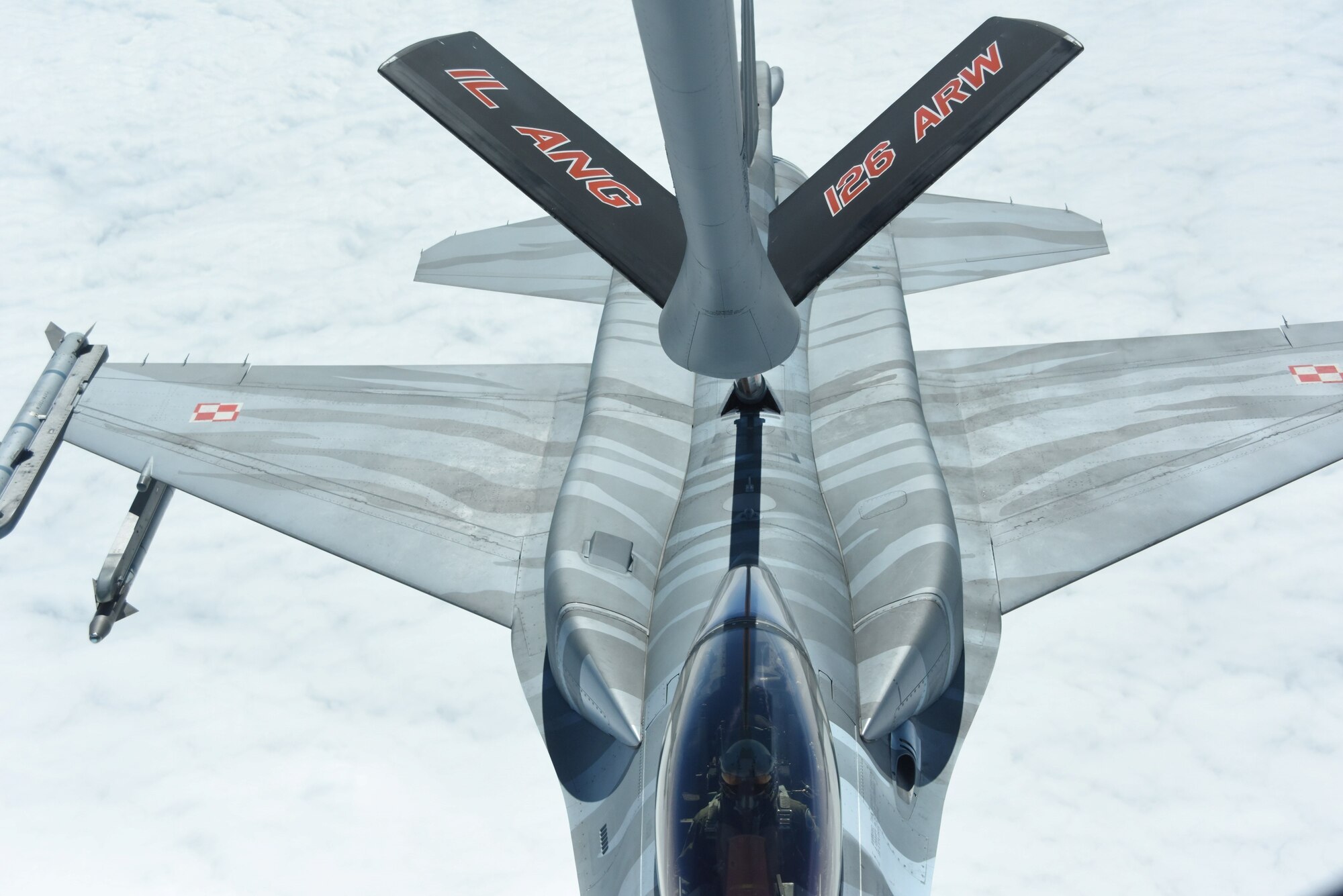 A Polish Air Force F-16 crew trains in aerial refueling with a U.S. Air Force KC-135.