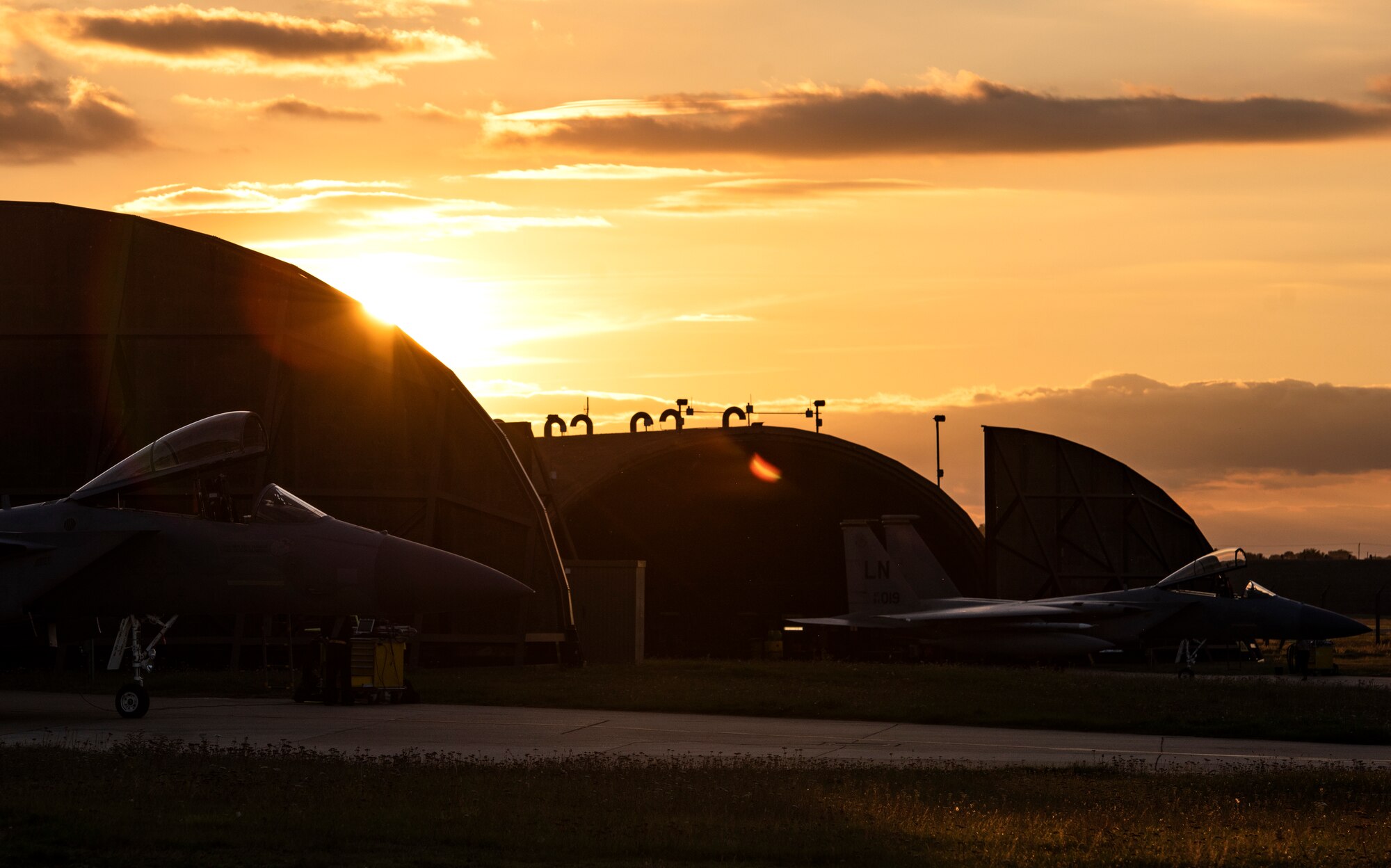 Two F-15C Eagles, assigned to the 493rd Fighter Squadron, are parked on the flightline prior to evening take-offs at Royal Air Force Lakenheath, England, Sept. 8, 2020. Night Flying Exercises provide 48th Fighter Wing aircrew and support personnel the experience needed to maintain a ready force capable of ensuring the collective defence of the NATO alliance. (U.S. Air Force photo by Airman 1st Class Jessi Monte)
