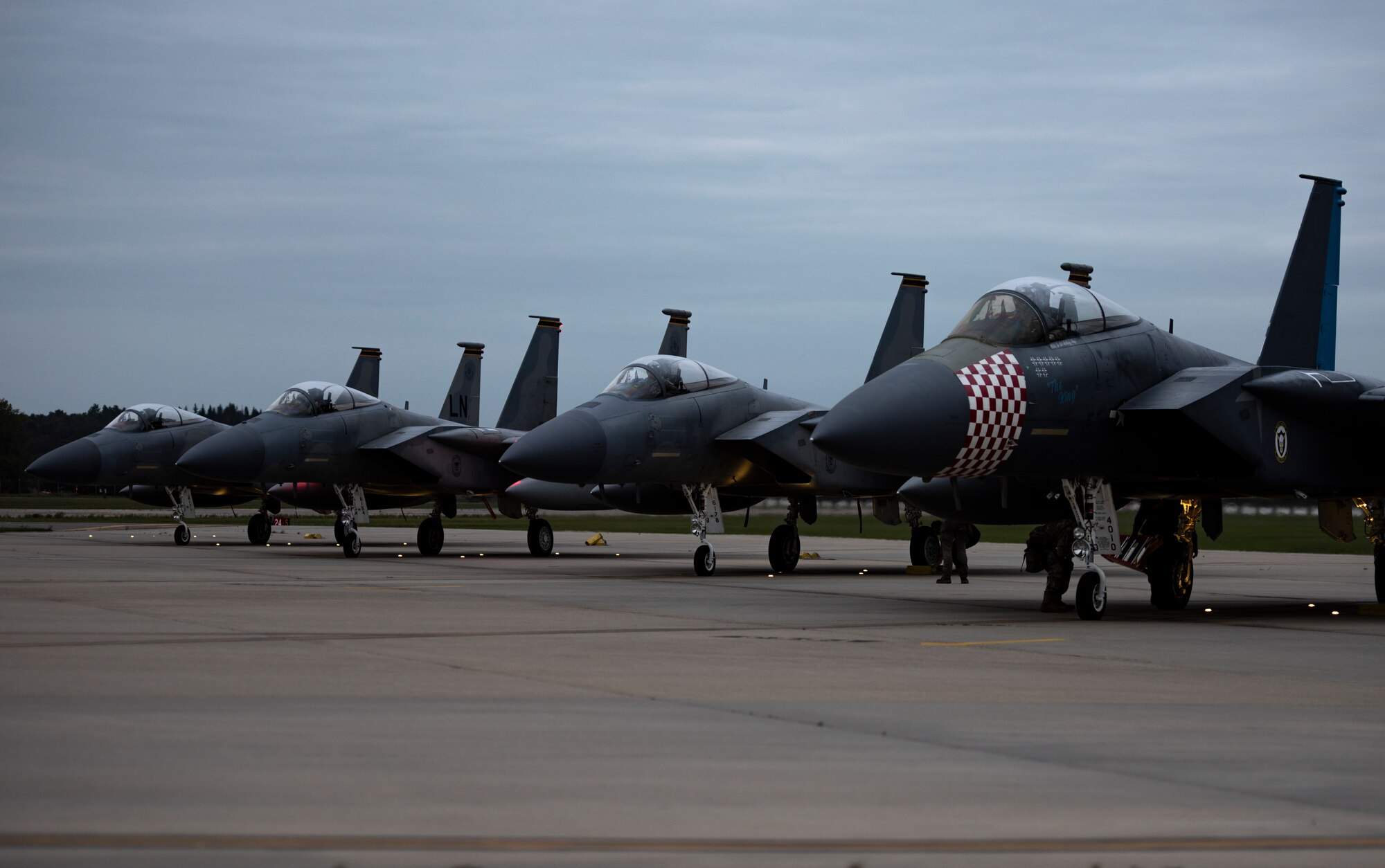 F-15C Eagles, assigned to the 493rd Fighter Squadron, line the taxiway for pre-flight checks at Royal Air Force Lakenheath, England, Sept. 10, 2020. Night Flying Exercises provide 48th Fighter Wing aircrew and support personnel the experience needed to maintain a ready force capable of ensuring the collective defence of the NATO alliance. (U.S. Air Force photo by Airman 1st Class Jessi Monte)
