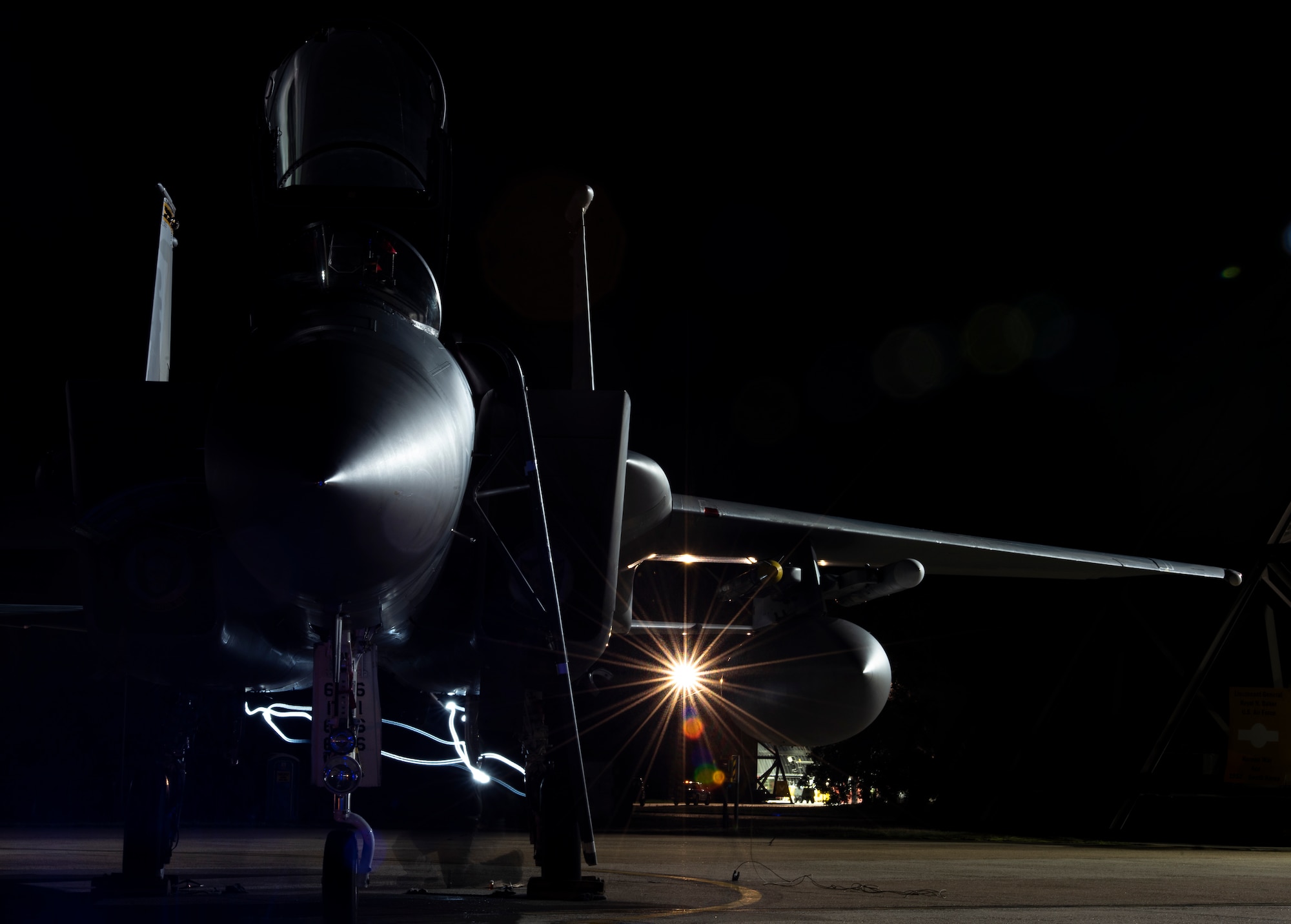 A U.S. Air Force crew chief, assigned to the 748th Aircraft Maintenance Squadron, performs routine post-flight maintenance on an F-15C Eagle at Royal Air Force Lakenheath, England, Sept. 8, 2020. Night Flying Exercises provide 48th Fighter Wing aircrew and support personnel the experience needed to maintain a ready force capable of ensuring the collective defence of the NATO alliance. (U.S. Air Force photo by Airman 1st Class Jessi Monte)