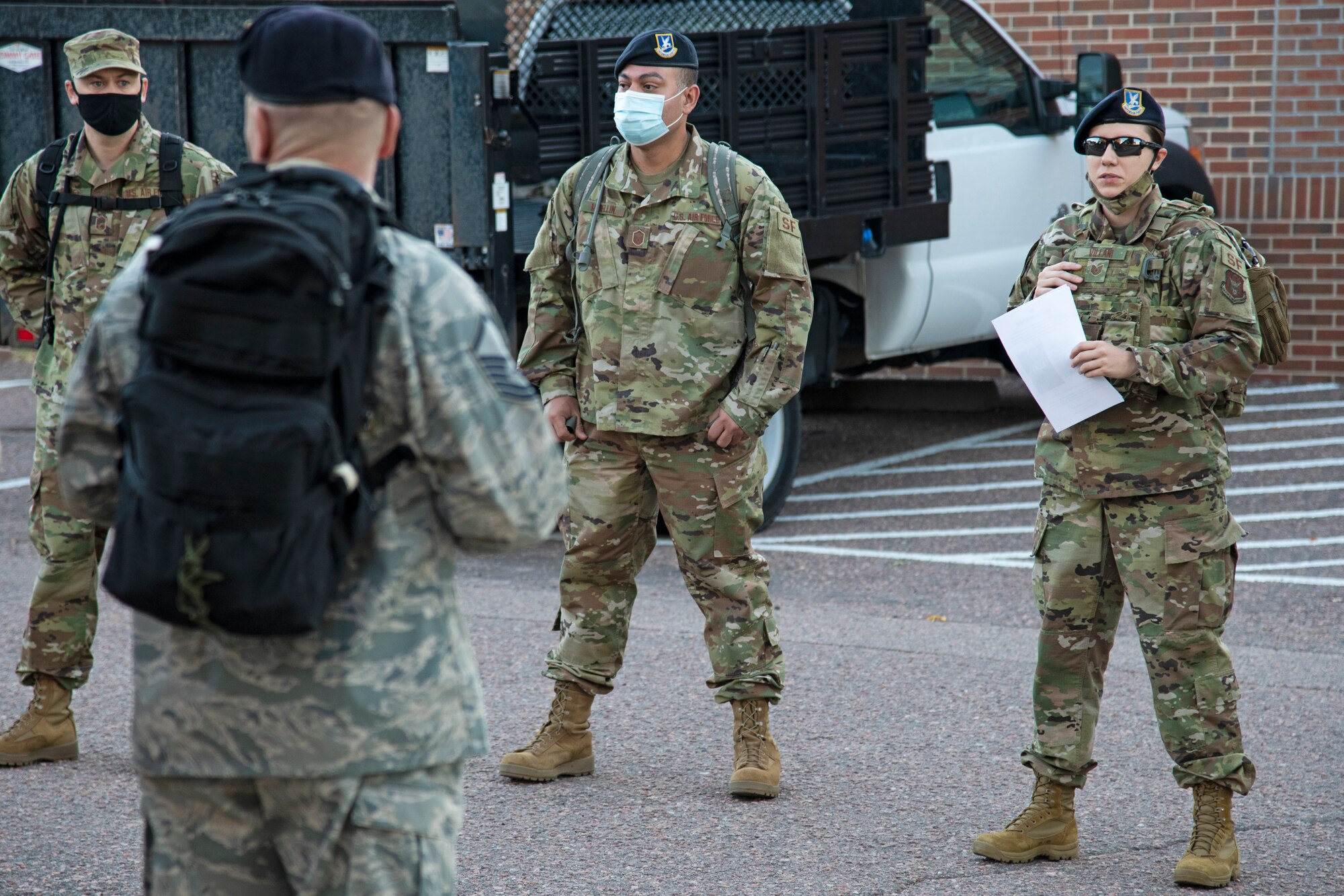 Tech. Sgt. Nicolina Villani, 302nd Security Forces Squadron, briefs fellows 302 SFS members before setting out on a Sunday morning ruck march at Peterson Air Force Base