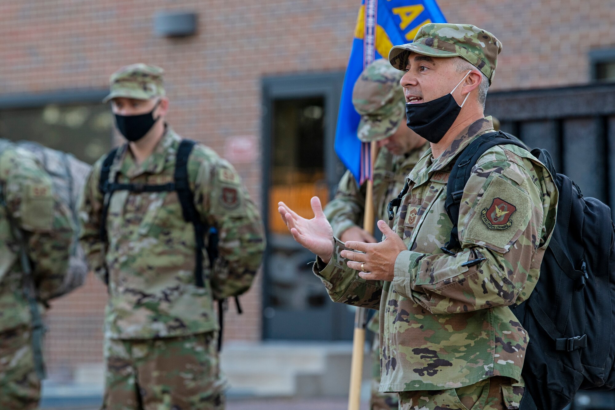 Chief Master Sgt. Kahn Scalise, 302nd Airlift Wing command chief, addresses members of the 302nd Security Forces Squadron before setting out on a ruck march at Peterson Air Force Base