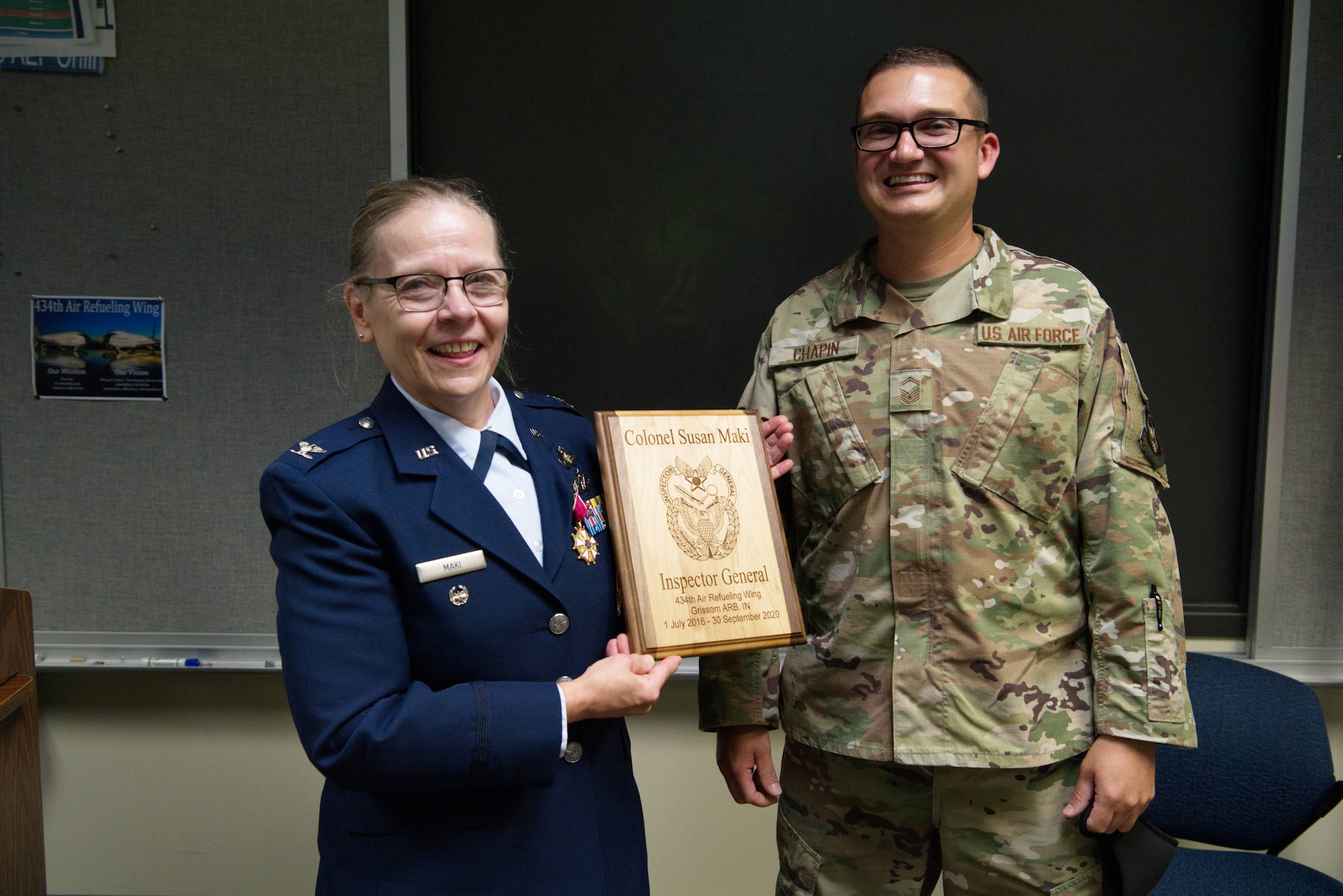 Master Sgt. Zach Chapin, 434th Air Refueling Wing inspections superintendent, presents a gift to Col. Susan Maki, 434th ARW inspector general, at a retirement ceremony at Grissom Air Reserve Base, Ind., Sept. 12, 2020. Maki retired after 32 years of service in the Minnesota Air Guard and Air Force Reserve. (U.S. Air Force Photo / A1C Harrison Withrow)