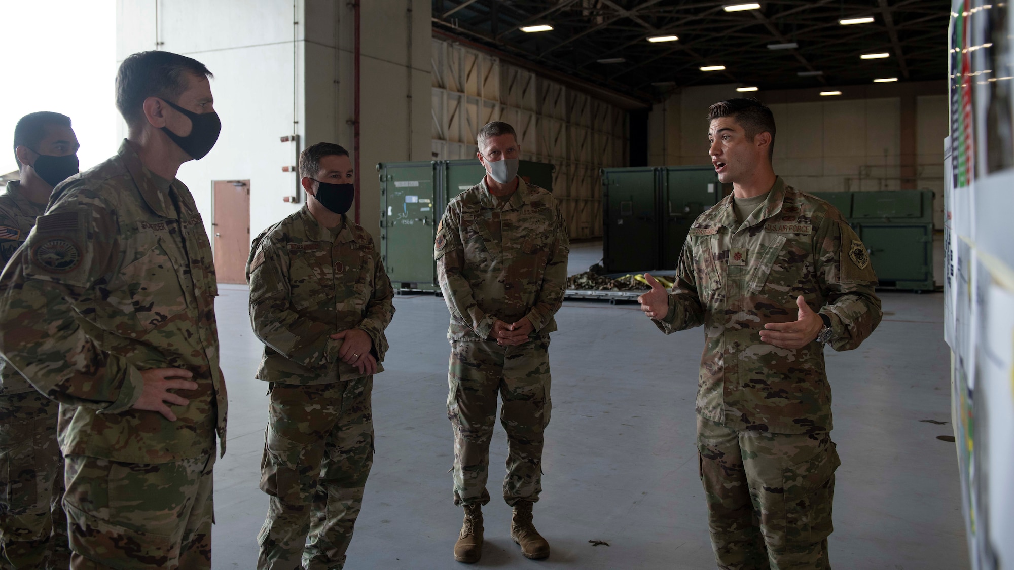 U.S. Air Force Lt. Gen. Kevin B. Schneider, U.S. Forces Japan and Fifth Air Force commander, and Chief Master Sgt. Rick Winegardner, USFJ senior enlisted leader, receive an F-15C Eagle maintenance brief from Maj. Alexander Pagano, 18th Aircraft Maintenance Squadron operations officer, Sept. 11, 2020, at Kadena Air Base, Japan. Lt. Gen. Schneider and Chief Master Sgt. Winegardner visited Team Kadena in order to learn more about how Airmen across the base are overcoming operational challenges during the COVID-19 pandemic. USFJ leadership also had the opportunity to communicate headquarters mission strategies directly to 18th Wing leaders. (U.S. Air Force photo by Staff Sgt. Peter Reft)