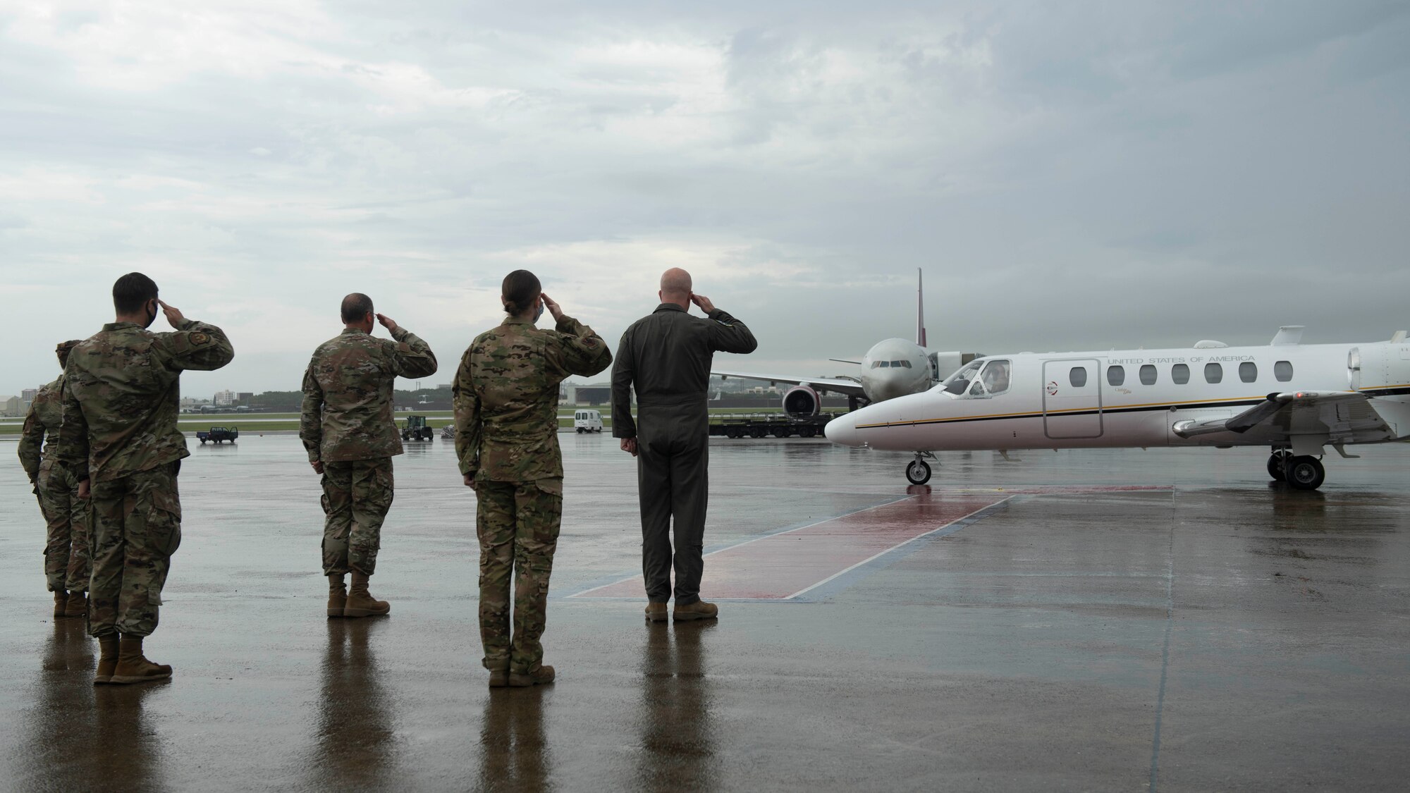 U.S. Air Force 18th Wing leaders salute the arrival of Lt. Gen. Kevin B. Schneider, U.S. Forces Japan and Fifth Air Force commander, Sept. 9, 2020, at Kadena Air Base, Japan. Lt. Gen Schneider visited Team Kadena in order to discuss topics such as mission readiness and counter-COVID operations. (U.S. Air Force photo by Staff Sgt. Peter Reft)