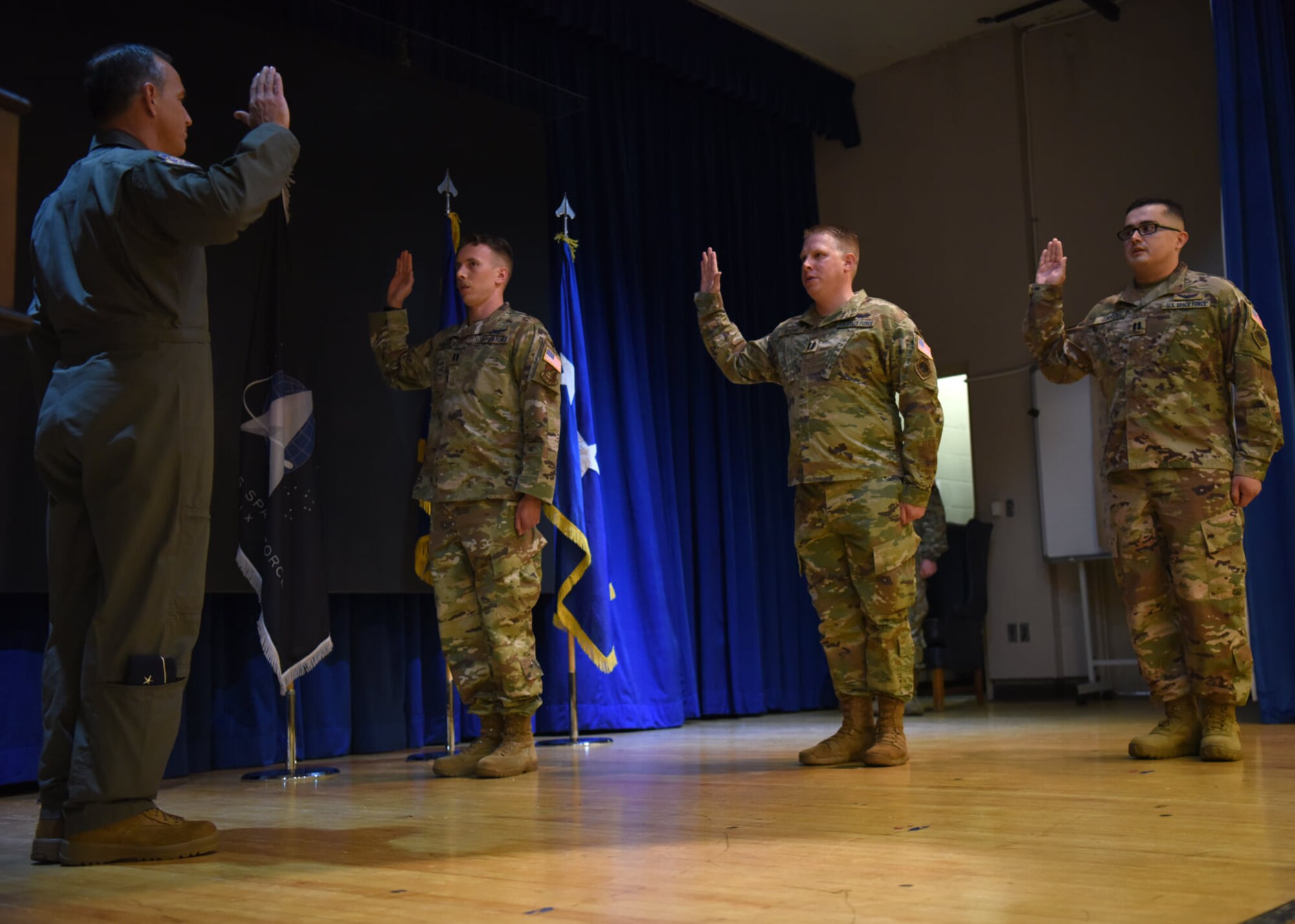 Lieutenant Gen. Scott Pleus, 7th Air Force commander, swears in three officers assigned to the 18th Intelligence Squadron, Detachment 2, during a U.S. Space Force enlistment and commissioning ceremony on Osan Air Base, Republic of Korea, Sept. 14, 2020. These officers will be the first official members of the USSF officer ranks on the Korean peninsula. (U.S. Air Force photo by Senior Airman Denise Jenson)
