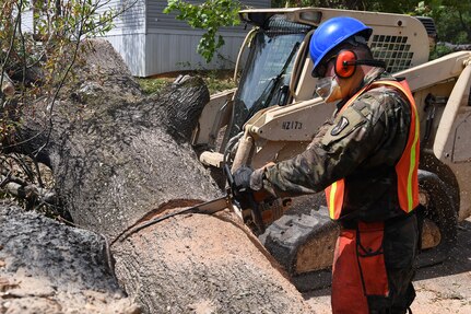 Louisiana National Guard Sgt. Wimer Jeremy with 1023rd Vertical Engineer Company, 528th Engineer Battalion, 225th Engineer Brigade, cuts through a fallen tree to assist with clearing roadways in Winnfield, La., during the recovery efforts from Hurricane Laura, Sept. 4, 2020.