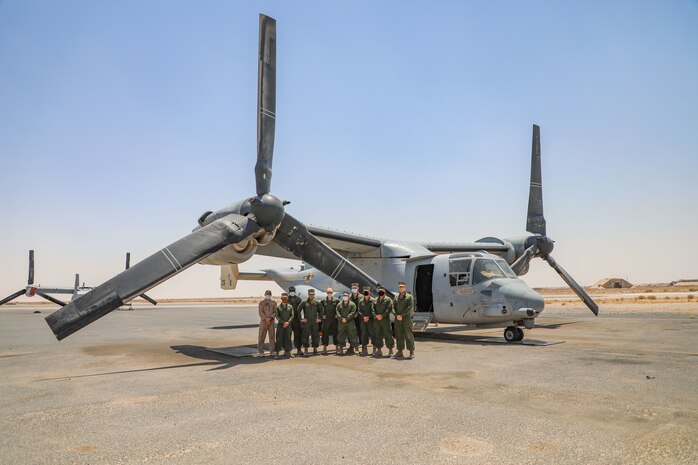 U.S. Navy Sailors stand in front of a MV-22B Osprey in Kuwait, Aug. 5.